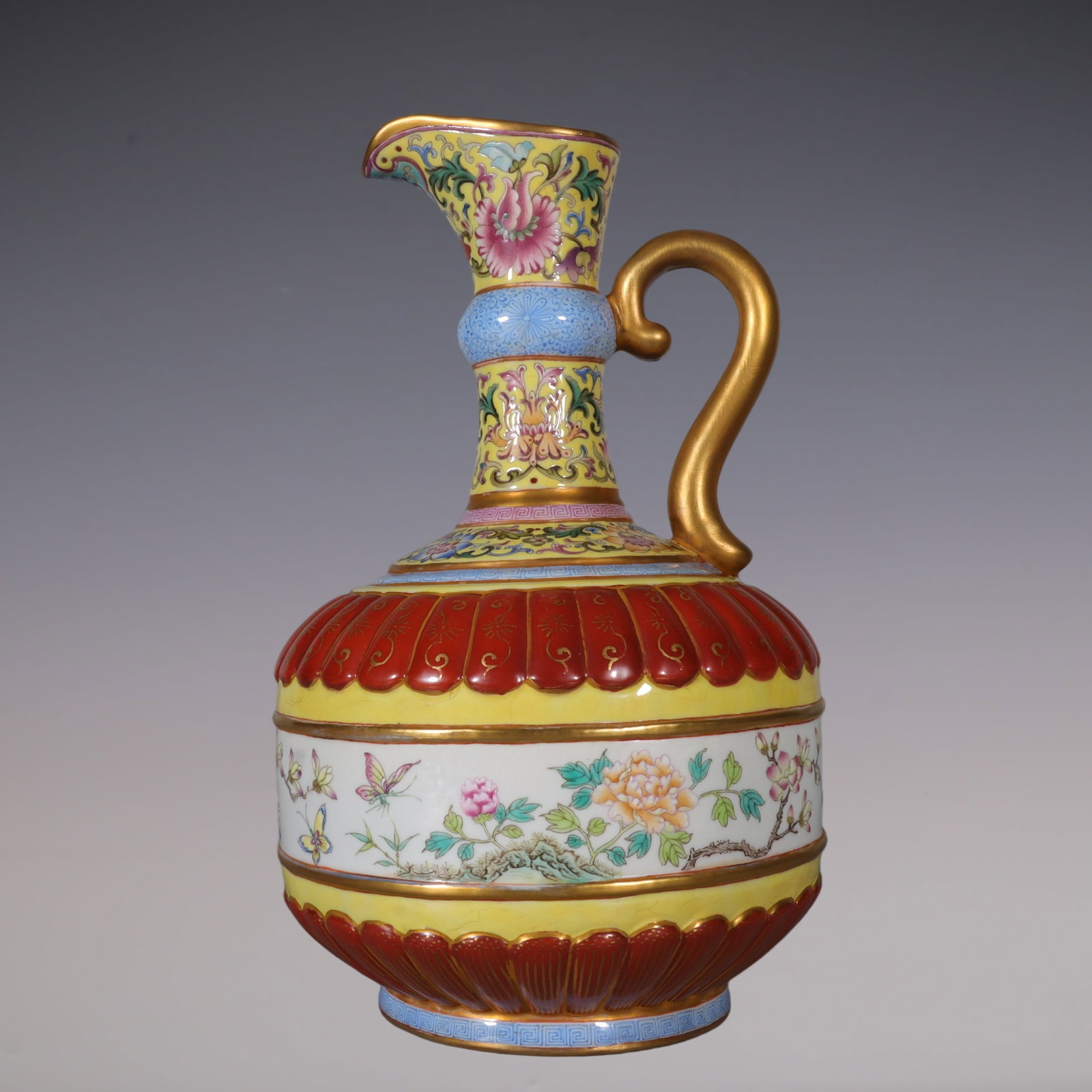 An Exquisite Enamel Iron-Red Painted Gold Flower and Butterfly Pattern Lotus Pattern Ewer: An Exquisite Enamel Iron-Red Painted Gold Flower and Butterfly Pattern Lotus Pattern Ewer Qing Dynasty, China Yongzheng Four-character Mark Size:23cmx13.5cm (The Dimensions Of All Batches Are