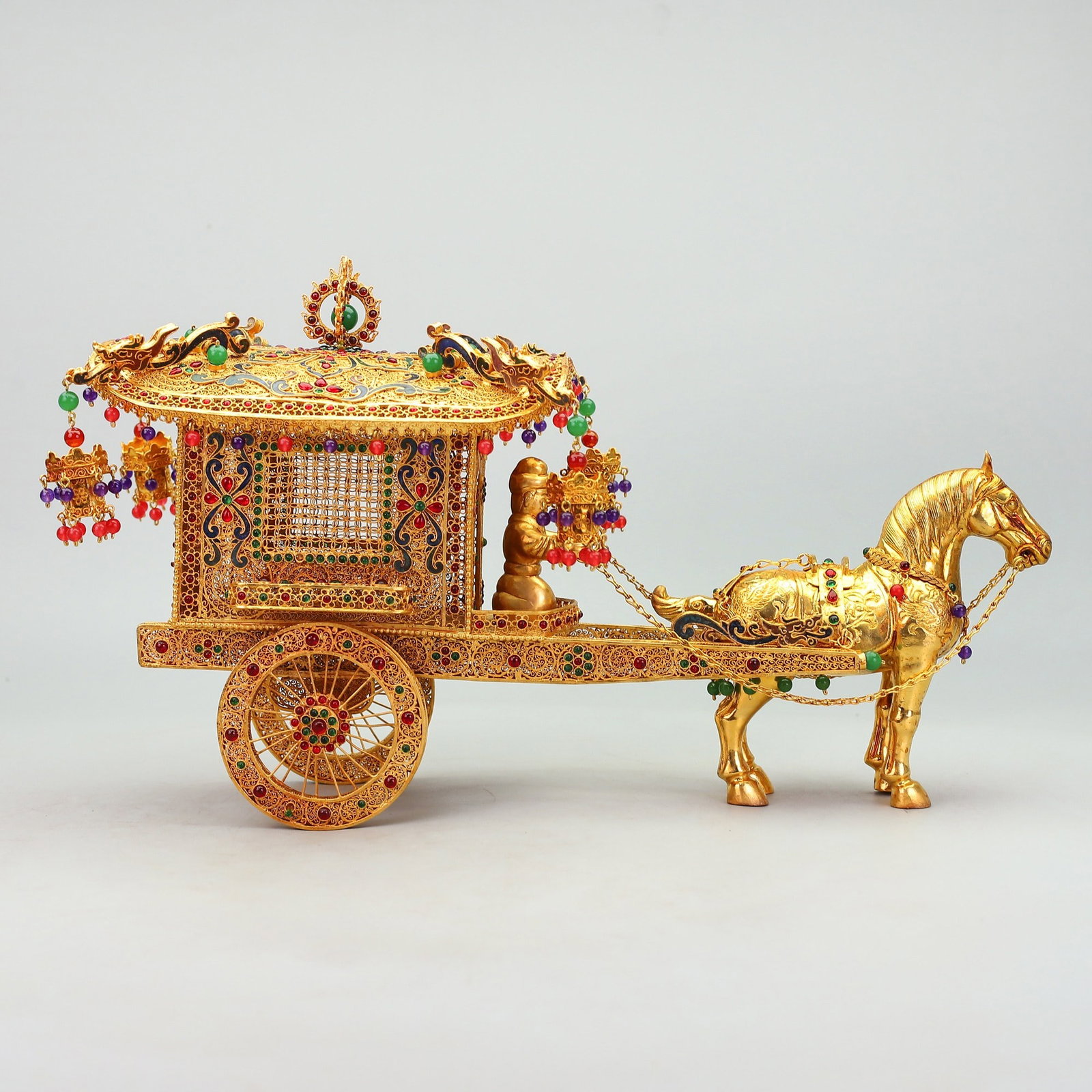 An Exquisite Gilt Bronze Inlaid Gems Carriage: An Exquisite Gilt Bronze Inlaid Gems Carriage Qing Dynasty, China Qianlong Four-character Mark Size:26cmx47cmx16cm Weight:1730g (The Dimensions Of All Batches Are Manually Measured.If You Need More
