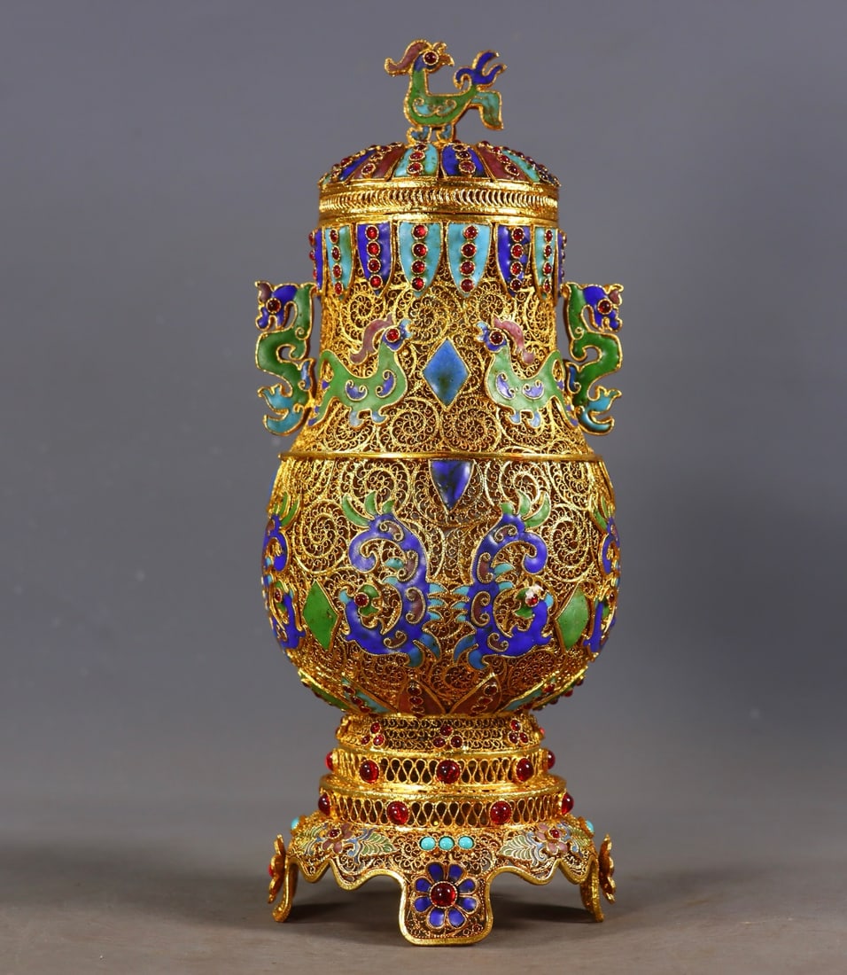 An Exquisite Gilt Bronze Inlaid Gems Flower and Bird Pattern Double-Ears Jar: An Exquisite Gilt Bronze Inlaid Gems Flower and Bird Pattern Double-Ears Jar Qing Dynasty, China Qianlong Four-character Mark Size:25.5cmx10cm Weight:628g (The Dimensions Of All Batches Are Manually M