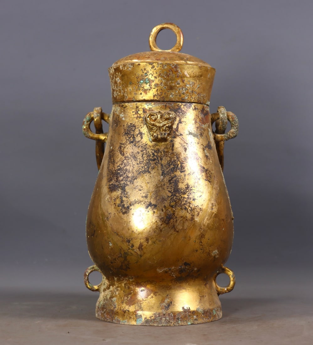 An Exquisite Gilt Bronze Beast-Face Pattern Jar: An Exquisite Gilt Bronze Beast-Face Pattern Jar Han Dynasty, China Size:27.5cmx13cmx12cm Weight:2181g (The Dimensions Of All Batches Are Manually Measured.If You Need More Detailed Information,