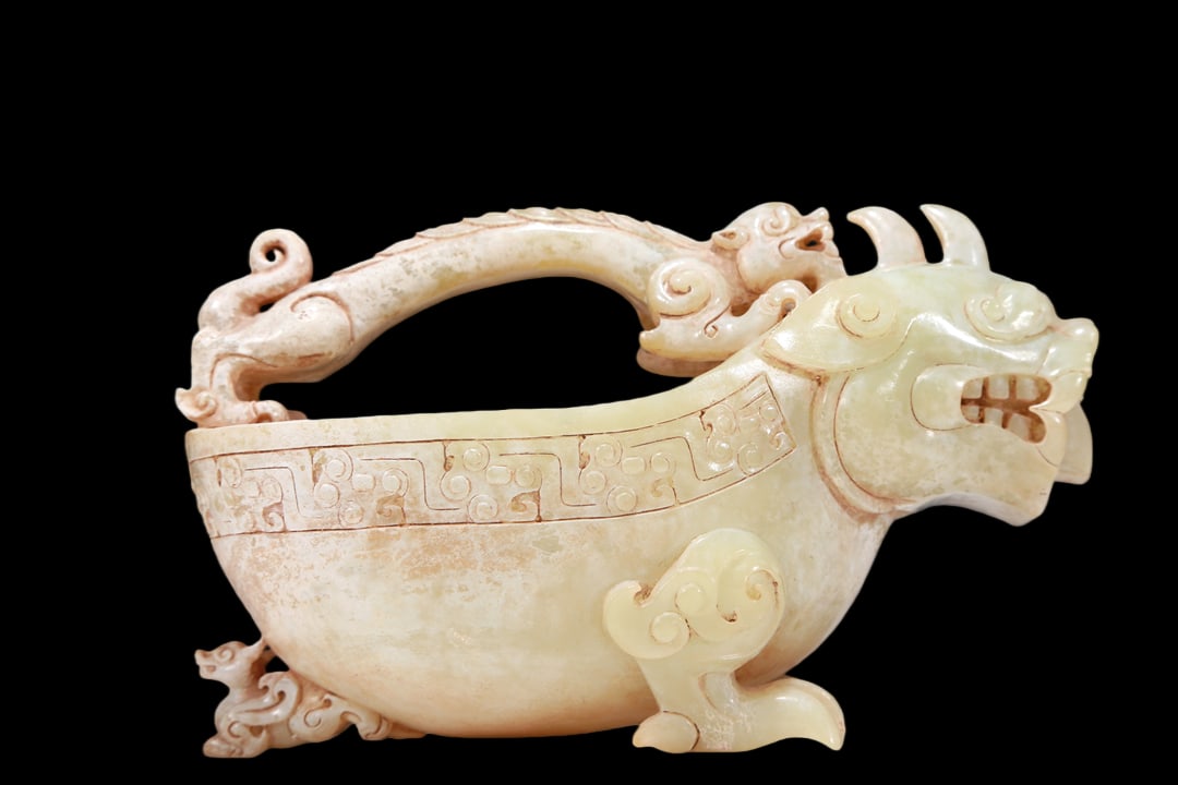 A Marvelous White Jade 'Auspicious Beast' Ewer: A Marvelous White Jade 'Auspicious Beast' Ewer. Body is carved with archaistic motifs, mouth slightly open, revealing fangs. Chinese Qing Dynasty. Size:14.5cmx8.2cmx9cm. Weight:500g (The Dimensions