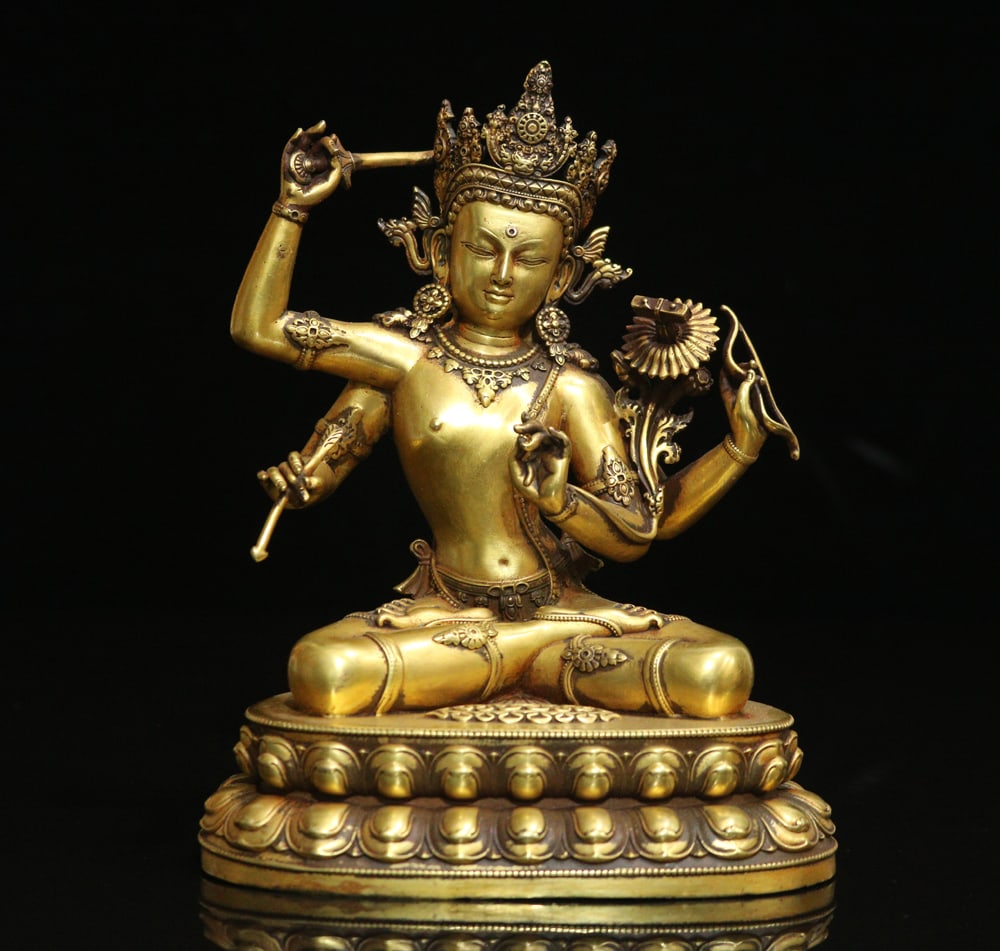An Exquisite Gilt Bronze Four-arms Statue of Manjusri Ornament: An Exquisite Gilt Bronze Four-arms Statue of Manjusri Ornament Ming Dynasty, China Yongle Six-character Mark Size:16cmx11.5cmx9cm Weight:1155g (The Dimensions Of All Batches Are Manually Measured.If Y