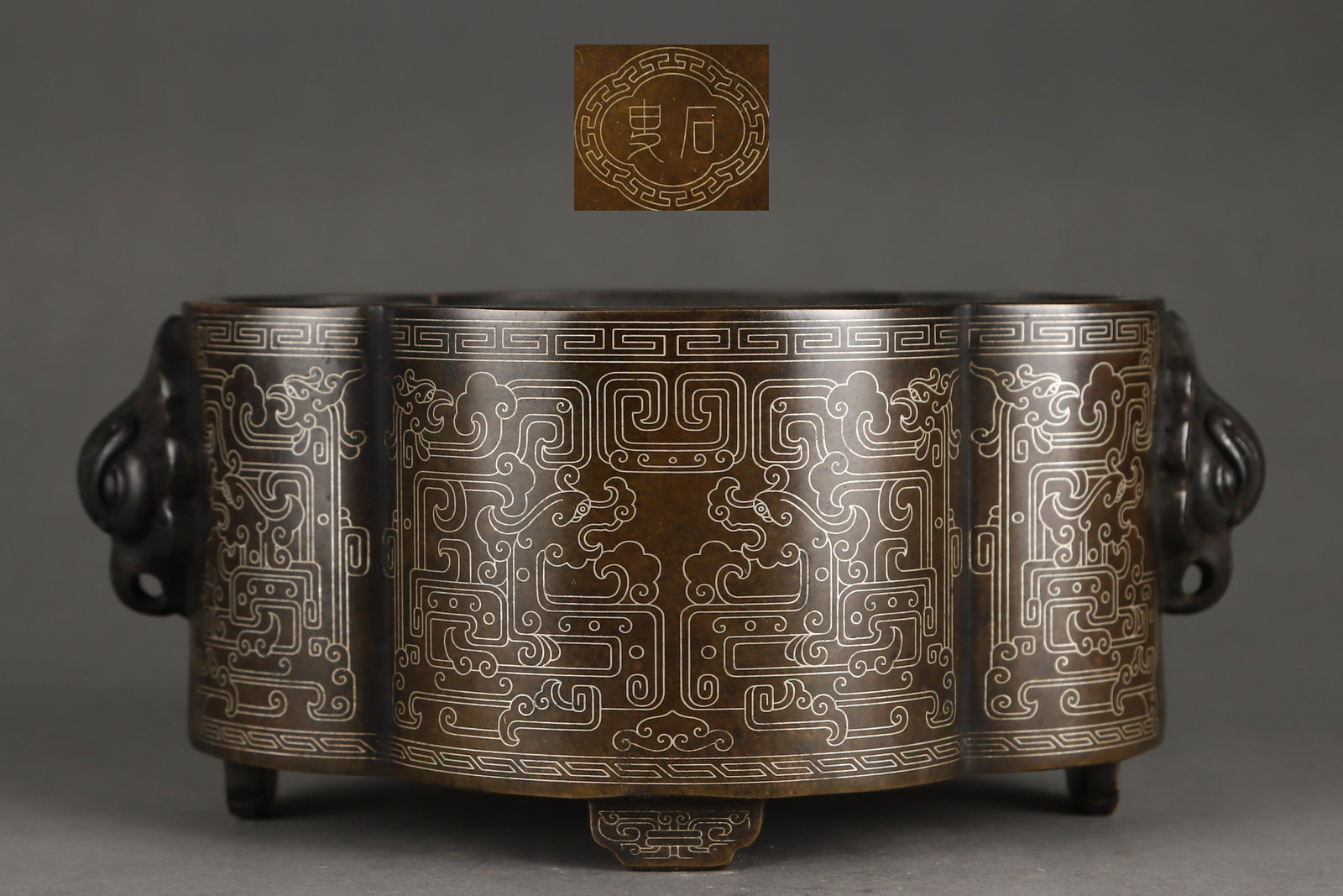 An Exquisite Bronze Inlaid Silver Dragon Pattern Double-Ears Censer: An Exquisite Bronze Inlaid Silver Dragon Pattern Double-Ears Censer Ming Dynasty, China Size:8cmx15cm Weight:2450g (The Dimensions Of All Batches Are Manually Measured.If You Need More Detailed