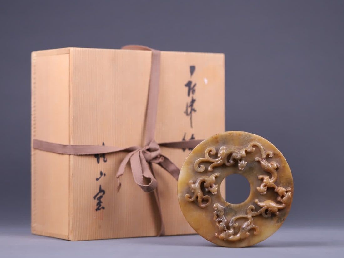A Han Dynasty ancient jade bi with relief carved chi dragon patterns: Han Dynasty ancient jade relief jade bi with chi dragon motif: The jade is fine in texture, with a warm and heavy patina, visible weathering marks on the surface, and an overall rustic and solid