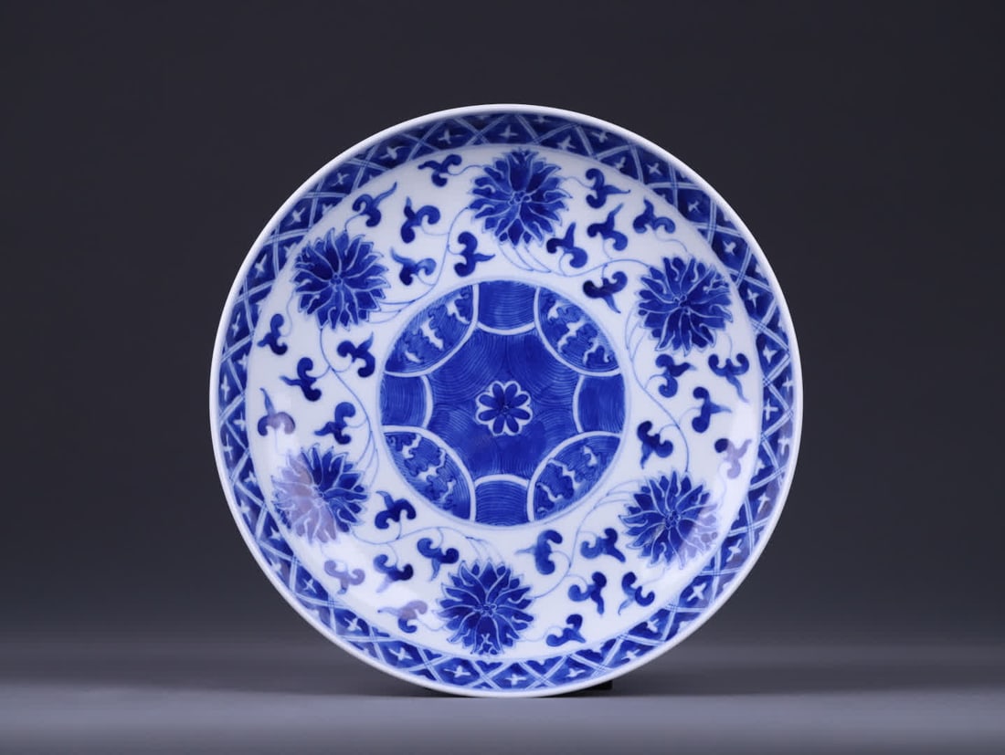 A Qing Dynasty plate with a 'Great Qing Guangxu Period' marked blue-and-white plate with entwined (1 of 9)