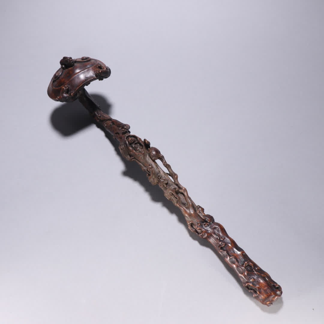 A ruyi handle from the Qing Dynasty with agarwood chi dragon motif (1 of 9)