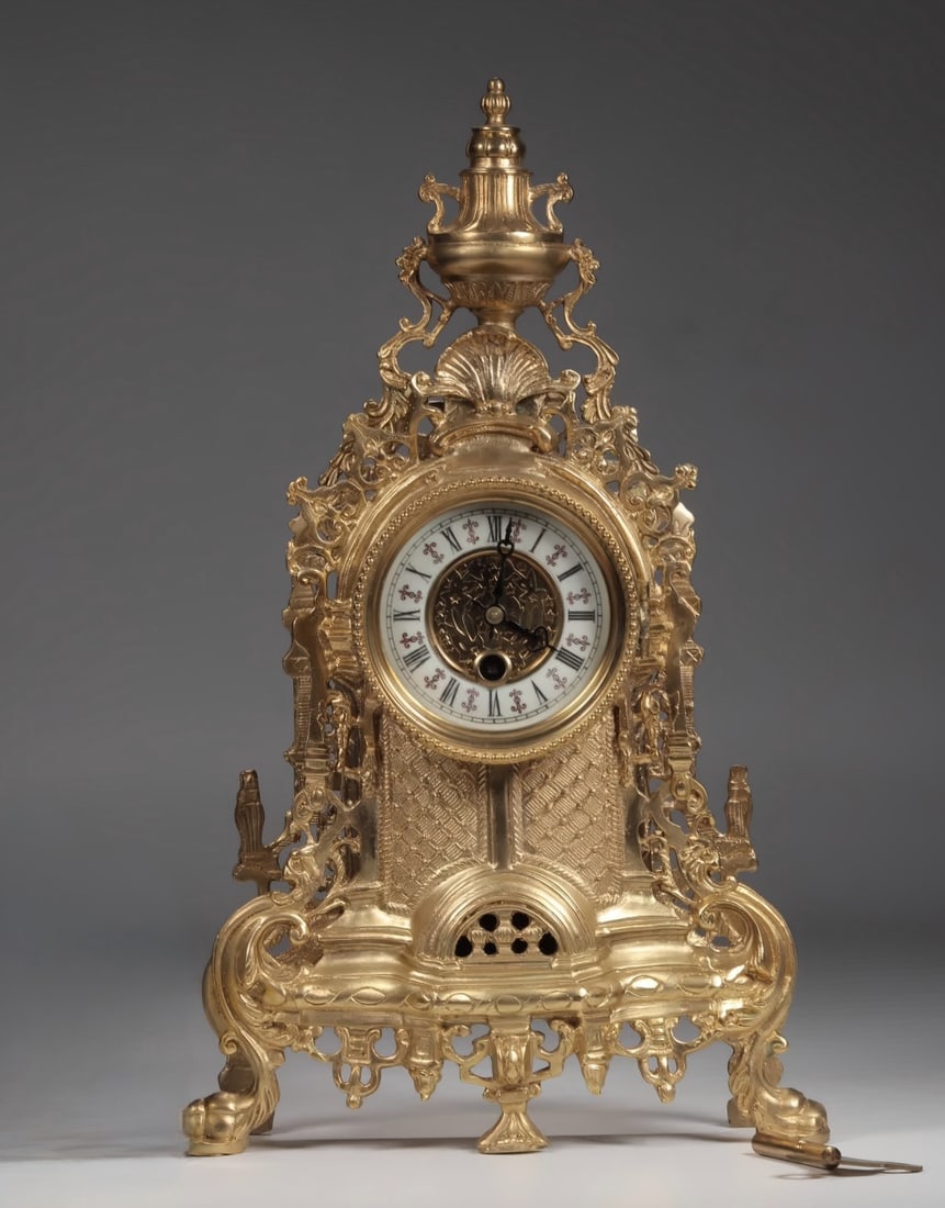 A late Qing dynasty gilt bronze scroll floral motif table clock: Late Qing dynasty gilt scroll floral motif standing clock SIZE: 23x8x30cm Weight: 2880g (The Dimensions Of All Batches Are Manually Measured.If You Need More Detailed Information, Please Contact Our