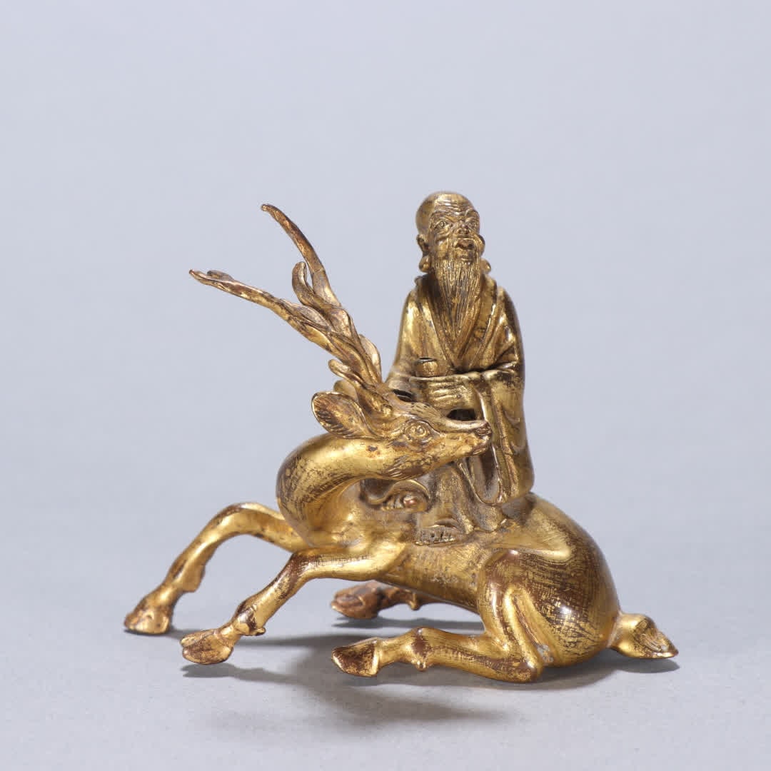 A gilt bronze longevity star riding a deer ornament: Gilt bronze longevity star riding deer ornament SIZE: H:5.8cm W:7.7cm W:170.9g (The Dimensions Of All Batches Are Manually Measured.If You Need More Detailed Information, Please Contact Our Customer