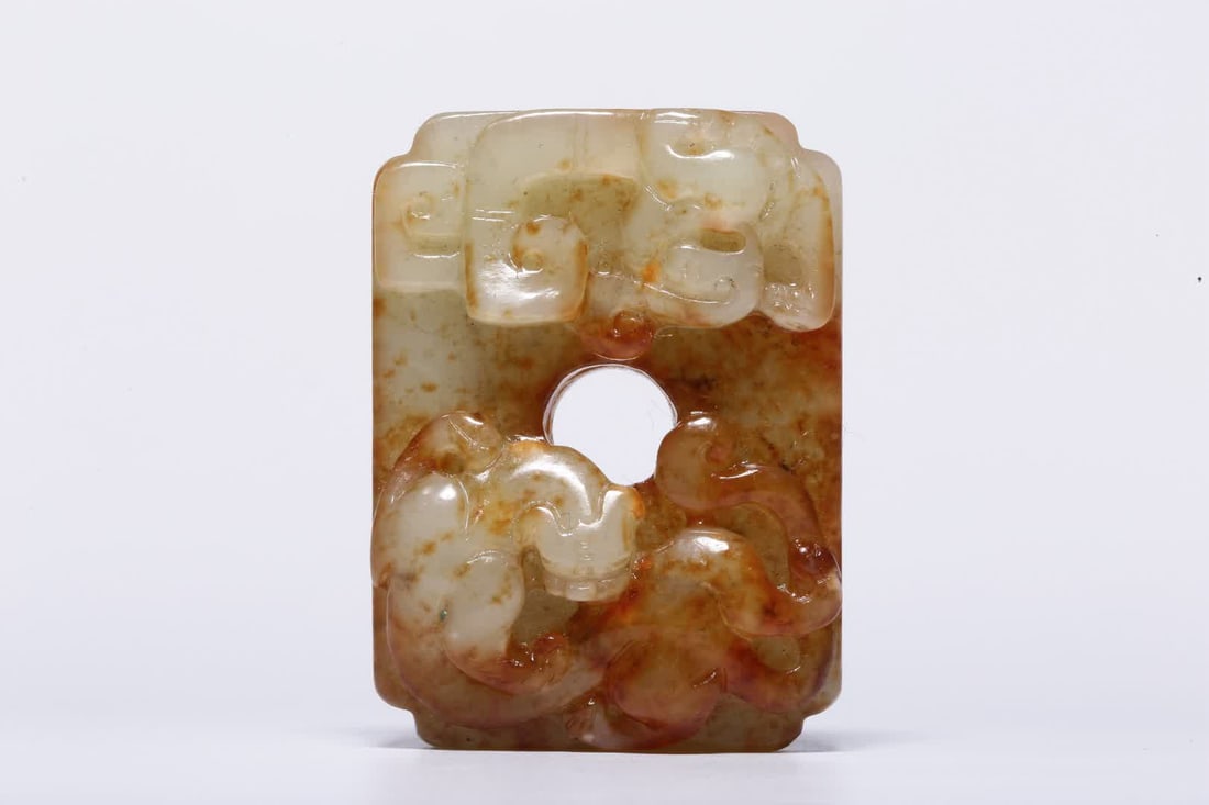 A pre-Ming dynasty Hetian jade square pendant with red indigo relief and double chi dragon patterns: Pre-Ming Dynasty Hetian Jade Red-Relief Double Chi Dragon Pattern Square Pendant This pendant is carved from Hetian jade, with a warm and dense texture, natural patina maturation, natural red color, a