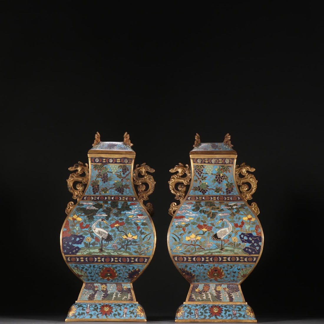 A pair of Qing dynasty gilt copper cloisonne "Pine and Crane for Longevity" double dragon-handled: Qing Dynasty: A pair of gilt bronze cloisonne 'Pine and Crane for Longevity' square zun with double dragon handles SIZE: H:23cm W:10.9cm W:1392.8g (The Dimensions Of All Batches Are Manually Measured.