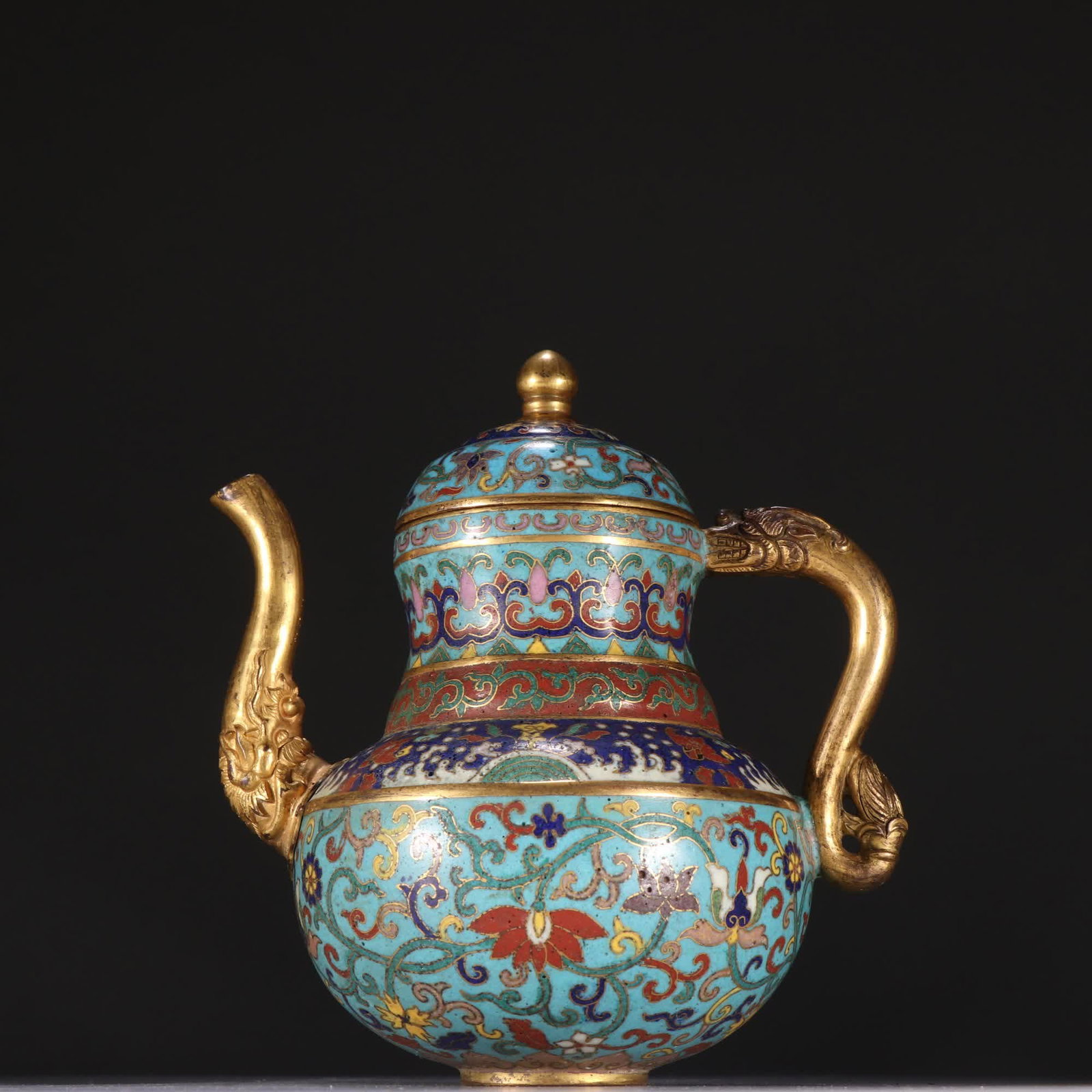 A Qing Dynasty copper gilt cloisonne teapot with entwined floral patterns: Qing Dynasty copper gilt cloisonne entwined floral teapot SIZE: H:15cm W:13.5cm W:660g (The Dimensions Of All Batches Are Manually Measured.If You Need More Detailed Information, Please Contact Our