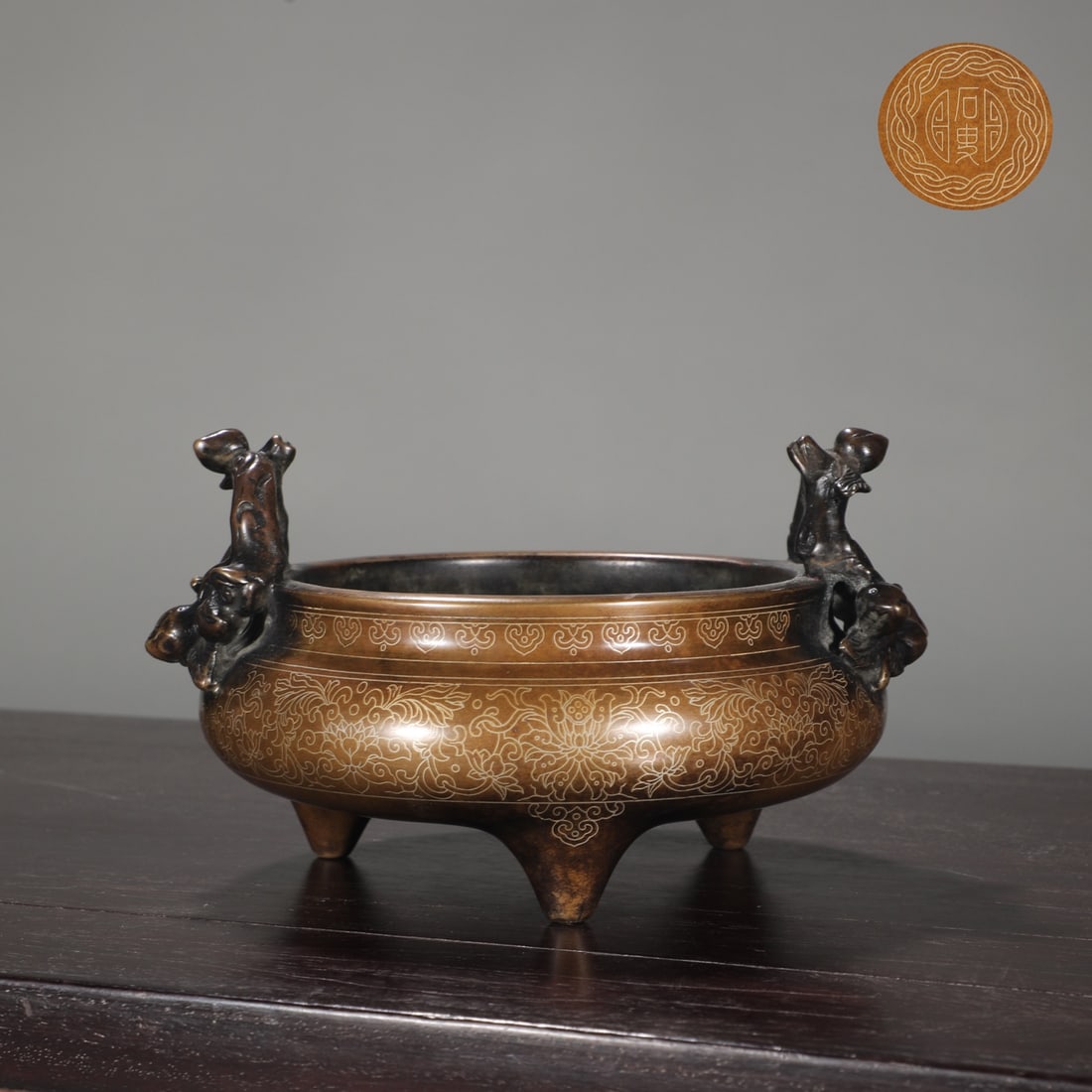 An Exquisite Bronze Inlaid Silver Lotus Pattern Double-Ears and Tripod Censer: An Exquisite Bronze Inlaid Silver Lotus Pattern Double-Ears and Tripod Censer Ming Dynasty, China Size:9.8cmx14.8cm Weight:1950g (The Dimensions Of All Batches Are Manually Measured.If You Need More