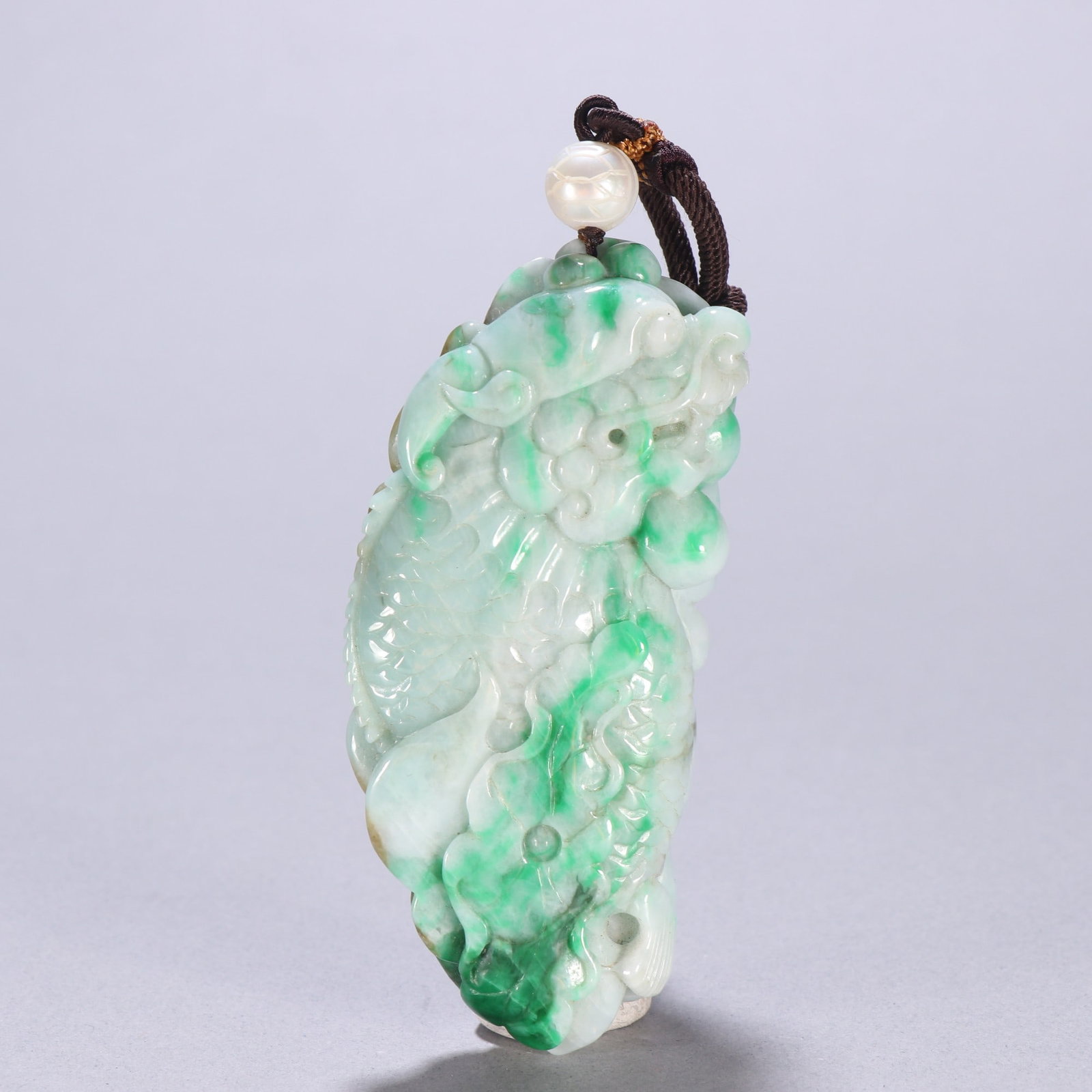 An Exquisite Jadeite Dragon Pattern Pendant: An Exquisite Jadeite Dragon Pattern Pendant Qing Dynasty, China Size:4.1cmx9.1cm Weight:116.1g (The Dimensions Of All Batches Are Manually Measured.If You Need More Detailed Information, Please