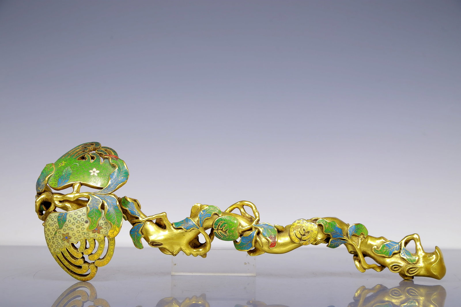 An Exquisite Gilt Bronze Cloisonne Pomegranate Ruyi: An Exquisite Gilt Bronze Cloisonne Pomegranate Ruyi Qing Dynasty, China Qianlong Four-character Mark Size:47cmx17cmx8cm Weight:3085g (The Dimensions Of All Batches Are Manually Measured.If You Need Mo