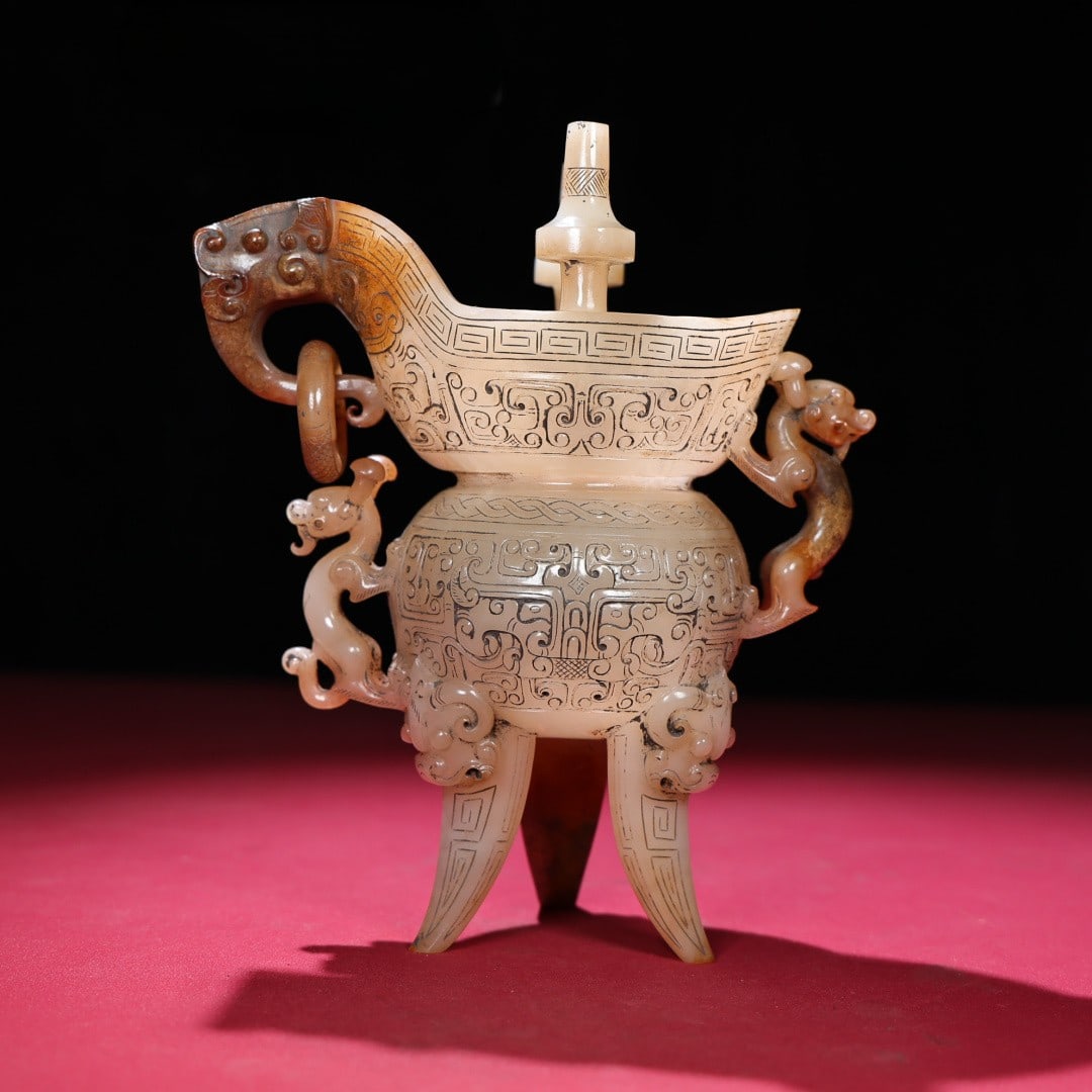 An Exquisite White Jade Beast-Face Pattern Tripod Goblet: An Exquisite White Jade Beast-Face Pattern Tripod Goblet Han Dynasty, China Size:17.7cmx15cmx7.7cm Weight:734g (The Dimensions Of All Batches Are Manually Measured.If You Need More Detailed Informatio