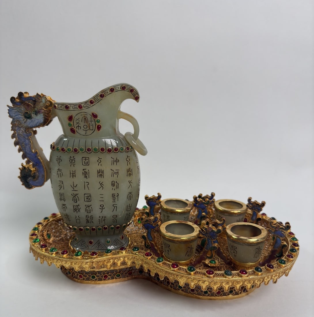 A Set of Fine Gilt Bronze Inlaid White Jade Ewer Cup: A Set of Fine Gilt Bronze Inlaid White Jade Ewer Cup Qing Dynasty, China Qianlong Four-character Mark Size:18cmx16cmx24cm Weight:978g Size:15cmx11.5cm Weight:369g Size:4.5cmx6.6cm Weight:45g (The Dime