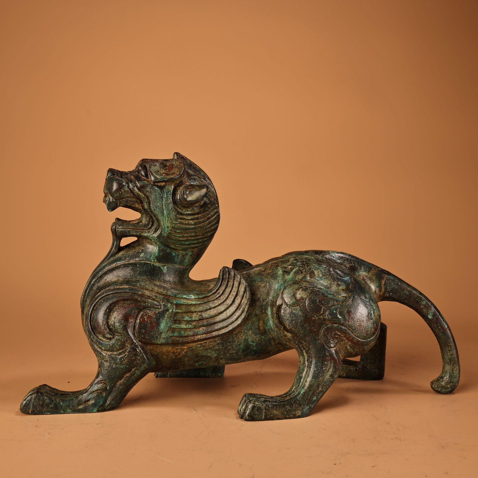 An Exquisite Bronze Auspicious Beast Ornament: An Exquisite Bronze Auspicious Beast Ornament Han Dynasty, China Size:18cmx32cm Weight:2200g (The Dimensions Of All Batches Are Manually Measured.If You Need More Detailed Information, Please Contact 