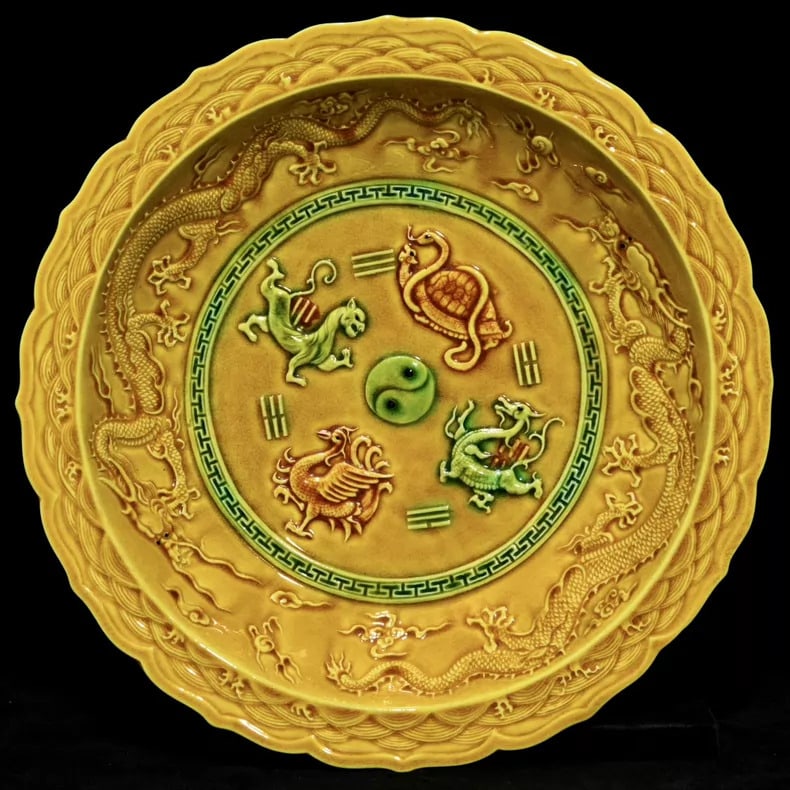 A fine Ming Dynasty Hongzhi Yellow Glaze Relief Plate with Four Divine Beast Motifs and Floral Mouth: Ming Dynasty Hongzhi Jiaohuang Glaze Relief Plate with Four Divine Beast Patterns Floral Mouth Plate SIZE: 5.8x33cm (The Dimensions Of All Batches Are Manually Measured.If You Need More Detailed Infor