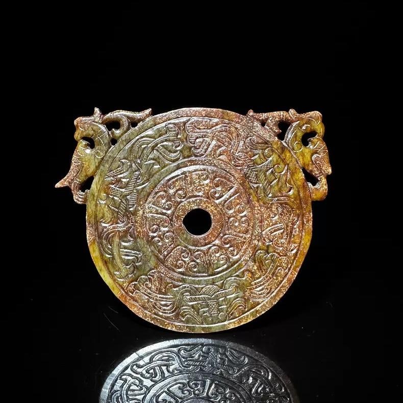 A fine piece of Han Dynasty Hetian jade, featuring dragons and phoenixes emerging from the outer: Han dynasty Hetian blue jade with dragons and phoenixes is a broad jade disc SIZE: H: approx. 13.06cm W: approx. 10.72cm W: 156.0g (The Dimensions Of All Batches Are Manually Measured.If You Need More