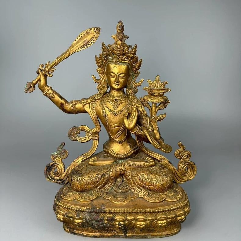 A fine Ming Dynasty gilt bronze statue of Manjushri Bodhisattva: Ming Dynasty gilt bronze statue of Manjushri Bodhisattva SIZE: L:20cm W:10.5cm H:23.8cm (The Dimensions Of All Batches Are Manually Measured.If You Need More Detailed Information, Please Contact Our C