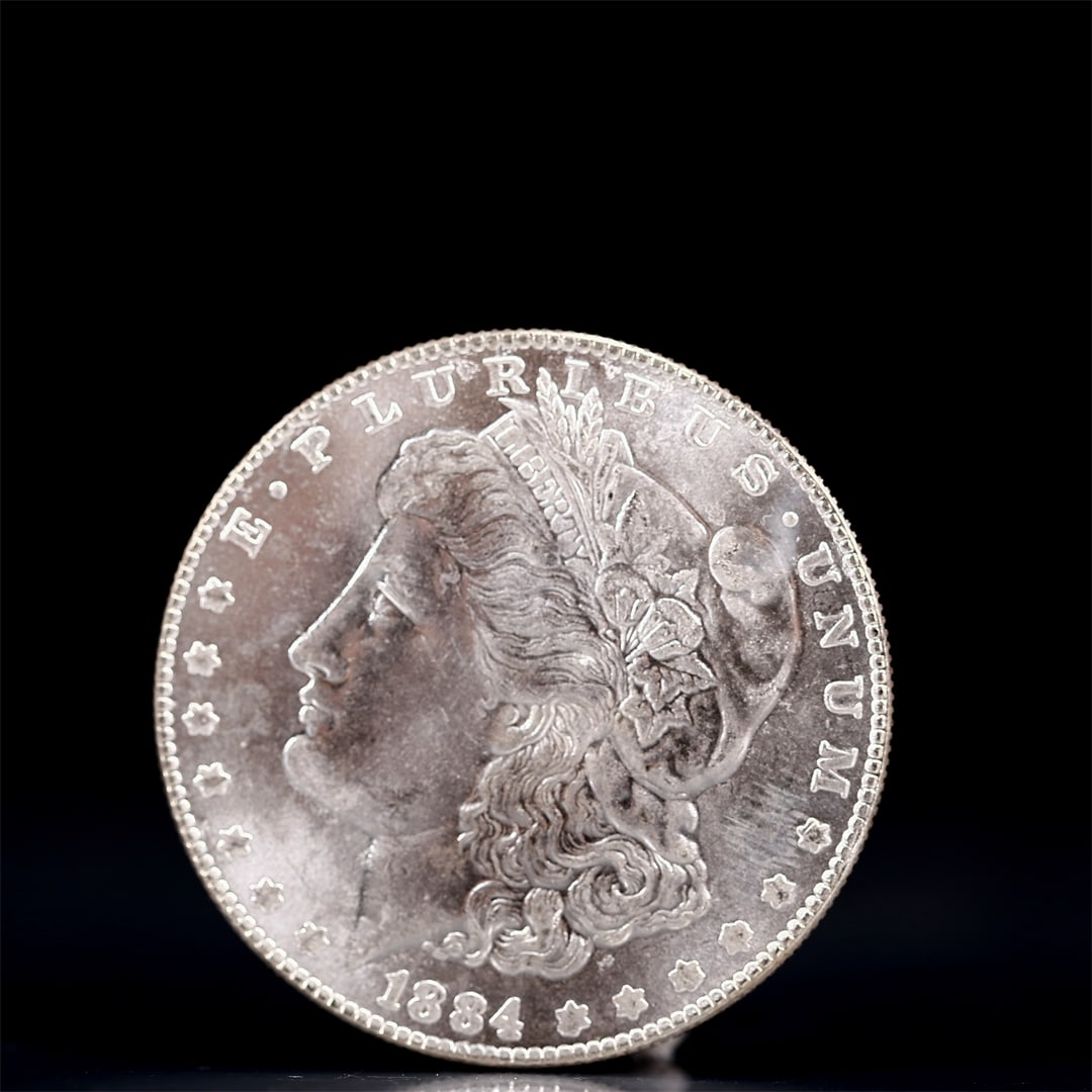 USA Morgan Dollar 1884 Coin: Obv: profile bust with date below and E PLURIBUS UNUM legend and stars around. Rev: eagle with In God we trust above within wreath with UNITED STATES OF AMERICA ONE DOLLAR legend. IN GOD WE TRUST / LI