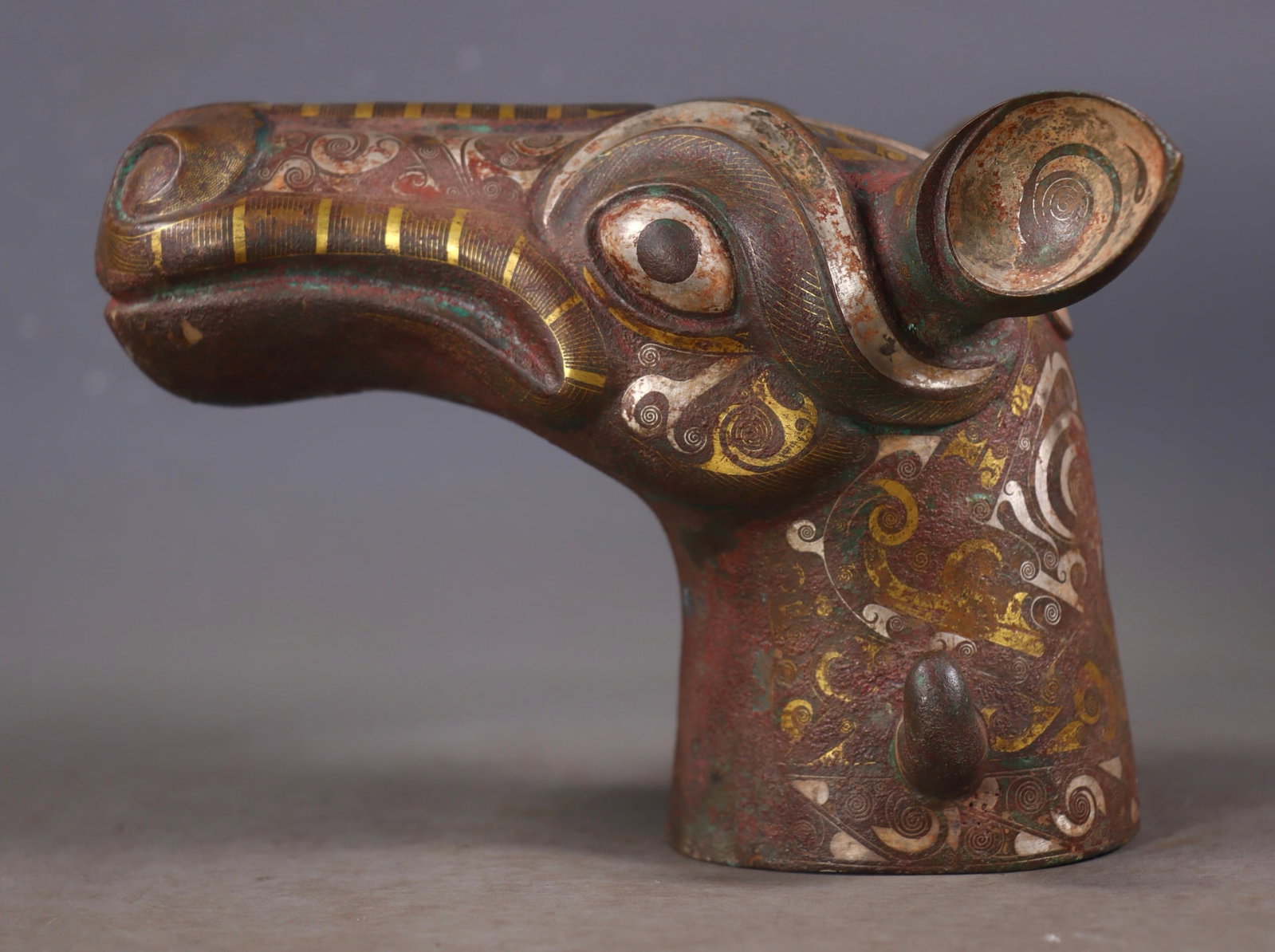 An Exquisite Bronze Inlaid Gold and Silver Horse head Ornament: An Exquisite Bronze Inlaid Gold and Silver Horse head Ornament Han Dynasty, China Size: 13cmx17.5cmx14cm Weight:2216g (The Dimensions Of All Batches Are Manually Measured.If You Need More Detailed Inf