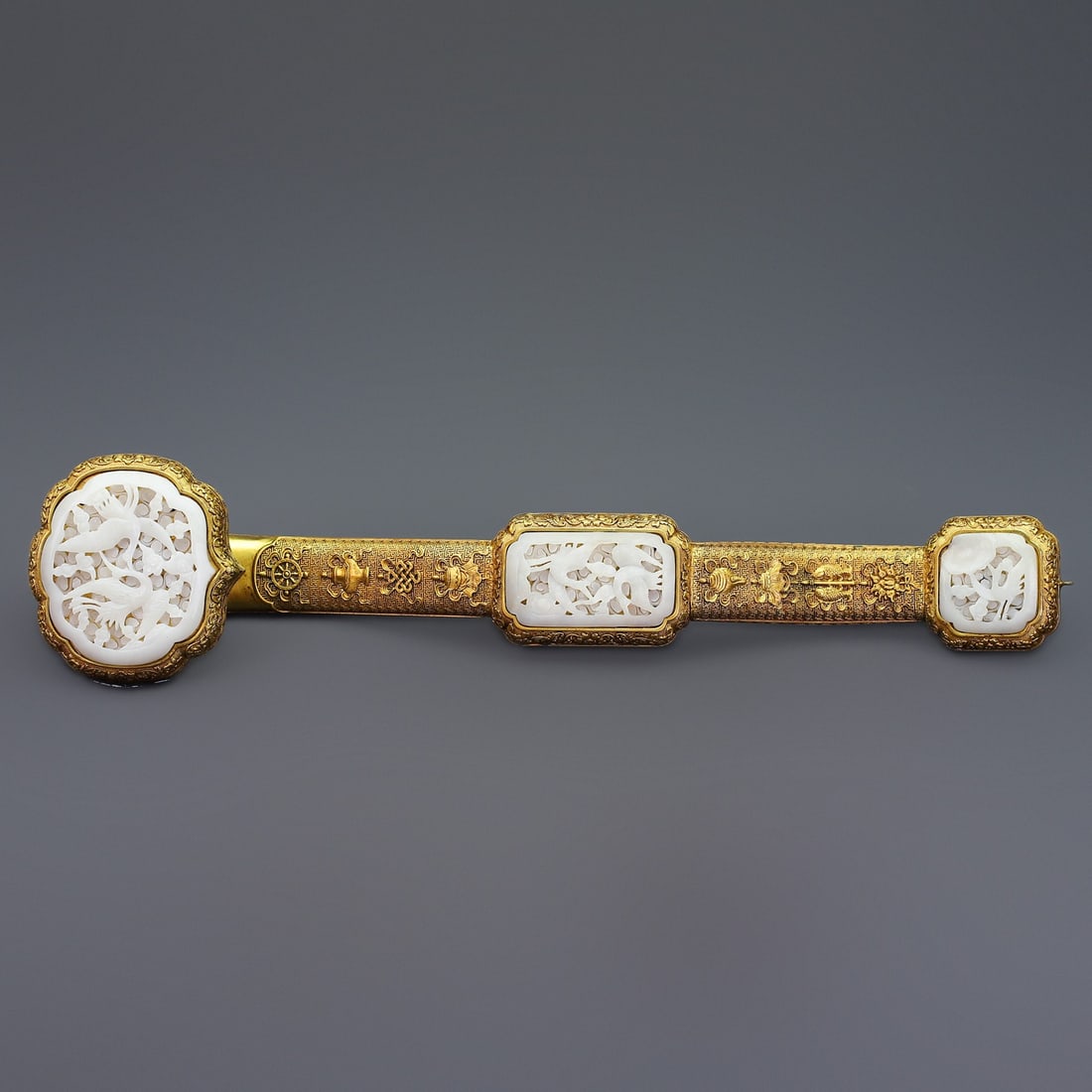 An Exquisite Gilt Bronze Inlaid White Jade Eight Treasures Pattern Flower and Bird Pattern Ruyi: An Exquisite Gilt Bronze Inlaid White Jade Eight Treasures Pattern Flower and Bird Pattern Ruyi Qing Dynasty, China Size:47cmx10cm Weight:1880g Size:53cmx23cmx29.5cm Weight:5585g (The Dimensions Of Al