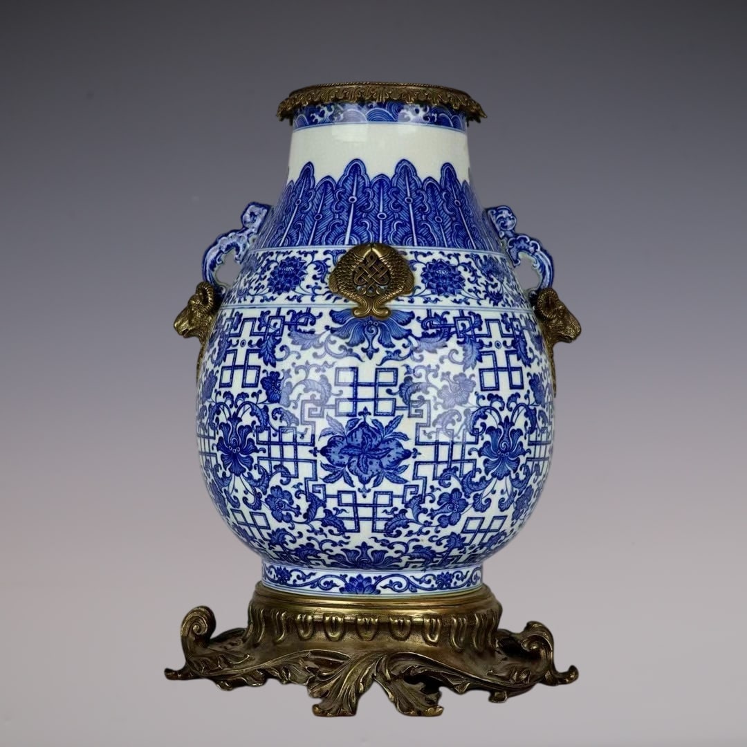 An Exquisite Blue and White Inlaid Bronze Lotus Pattern Double-Ears Vase: An Exquisite Blue and White Inlaid Bronze Lotus Pattern Double-Ears Vase Qing Dynasty, China Qianlong Six-character Mark Size:49cmx28cm (The Dimensions Of All Batches Are Manually Measured.If You