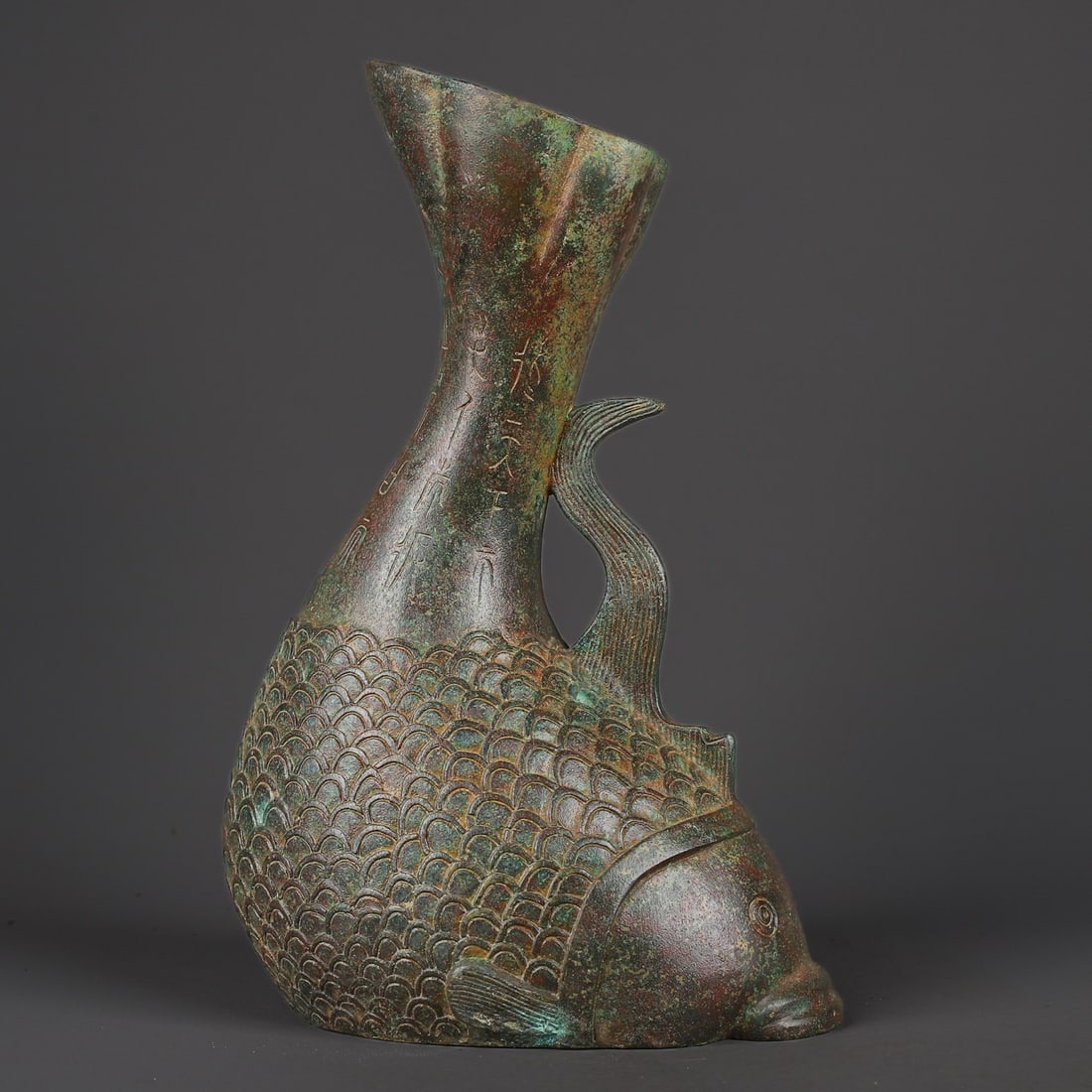 An Exquisite Bronze With Inscription Fish-Shaped Vase: An Exquisite Bronze With Inscription Fish-Shaped Vase Han Dynasty, China Size:21cmx32cm Weight:2330g (The Dimensions Of All Batches Are Manually Measured.If You Need More Detailed Information, Please