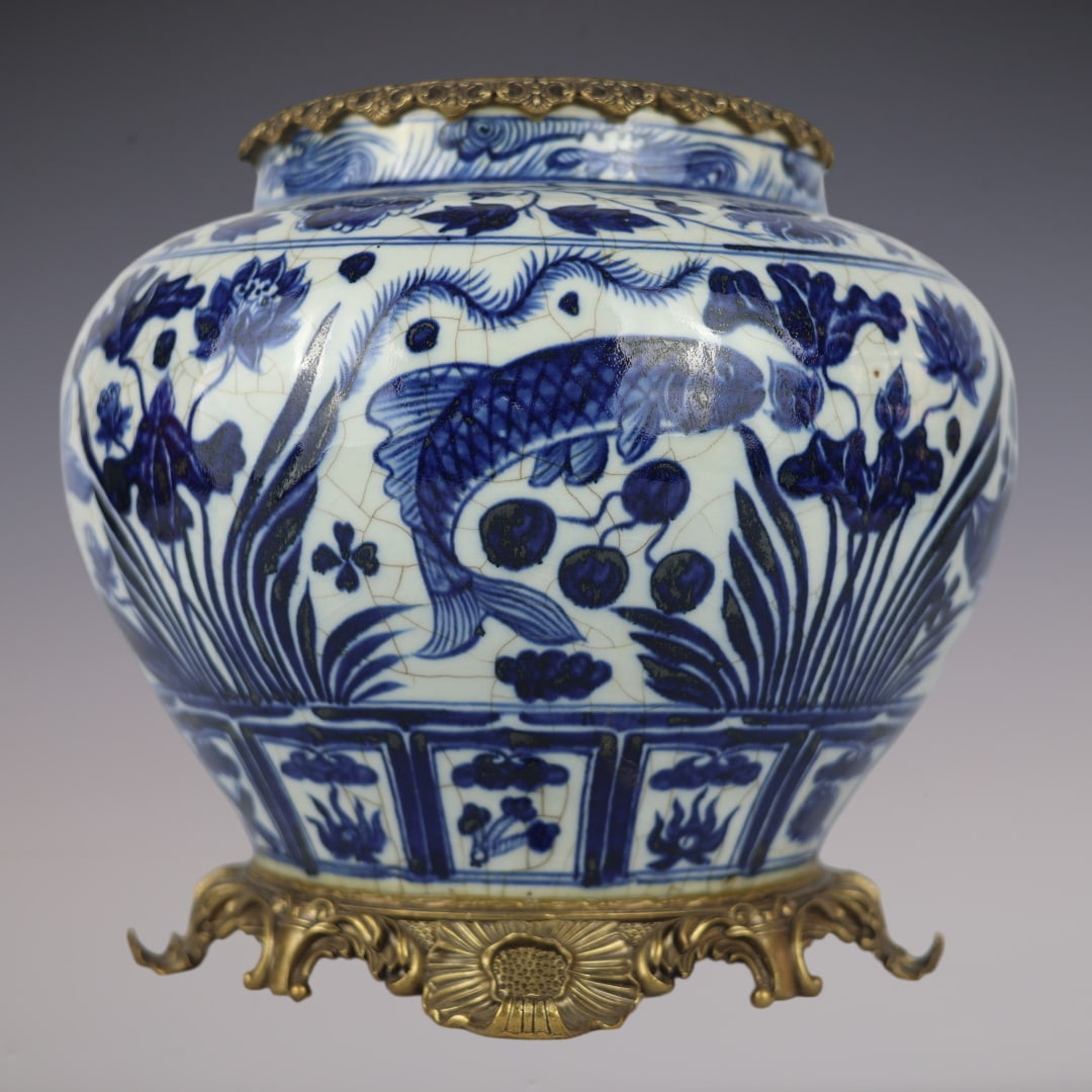 An Exquisite Blue and White Underglaze-Red Inlaid Bronze Fish and Lotus Pattern Jar: An Exquisite Blue and White Underglaze-Red Inlaid Bronze Fish and Lotus Pattern Jar Yuan Dynasty, China Size:33cmx30cm (The Dimensions Of All Batches Are Manually Measured.If You Need More Detailed In