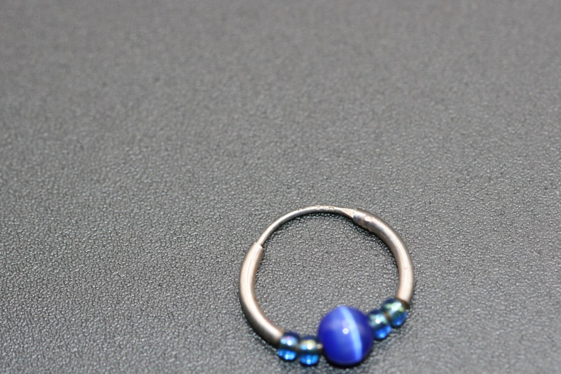 Cats eye Blue Mini hoop Single earring Pierced Sterling Silver 925 signed .Lot#85: Cats eye Blue Mini hoop single earring Pierced Sterling Silver 925 signed on one of the earring hooks sterling measures 1/2" in diameter