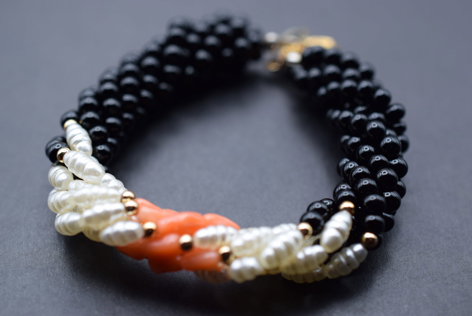 Coral Onyx Pearl Genuine Braided Bracelet Lot 939: Coral Onyx Pearl Genuine Braided Bracelet measures 7" Long wear to the back of the clasp