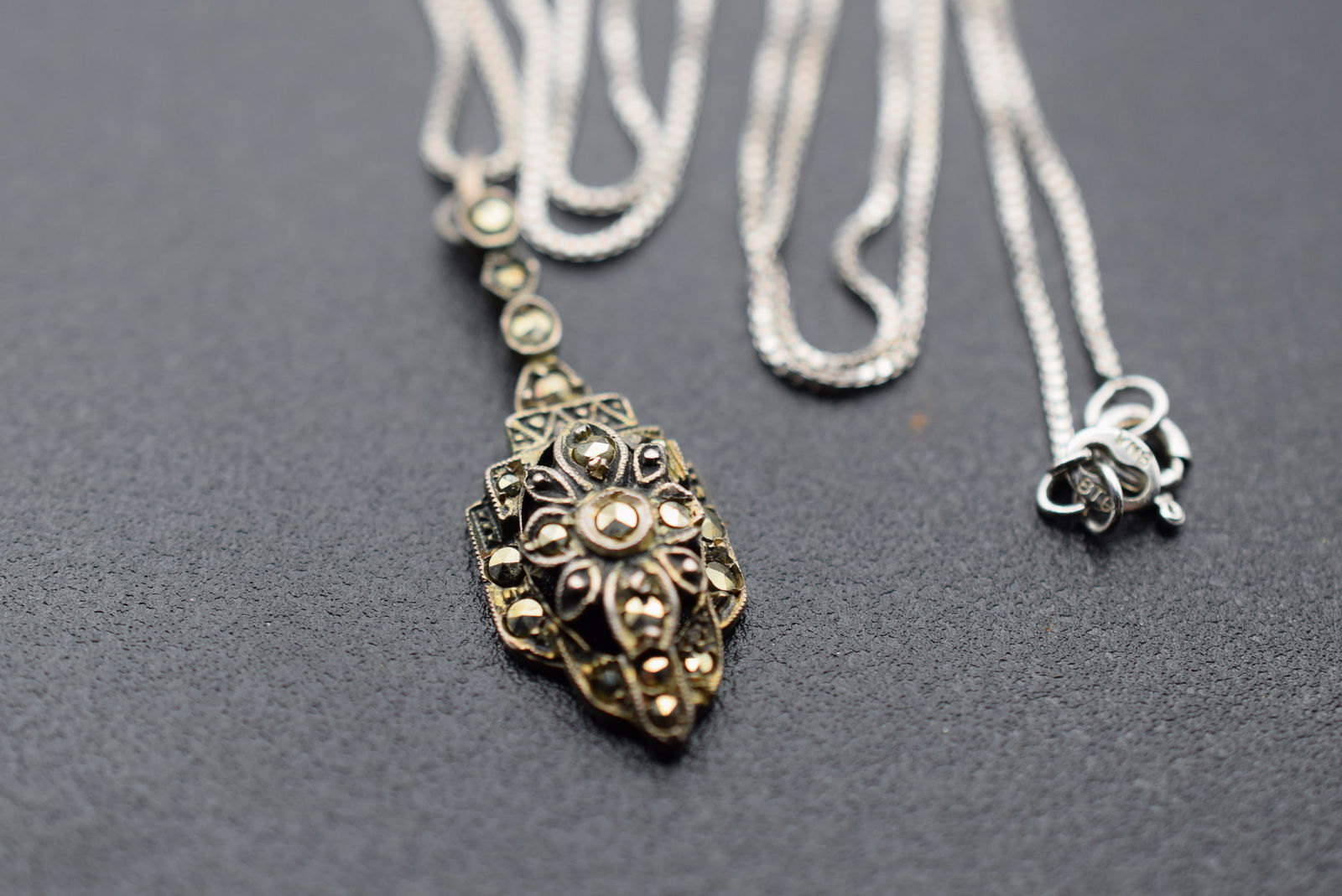 Marcasite Sterling Vintage Necklace Germany Lot 1195: Marcasite Sterling Vintage Necklace Germany Pendant measures 1 1/4" x 1/2" and the chain measures 18" long the pendant is stamped Sterling Germany and the Box chain is stamped Sterling on the spring R