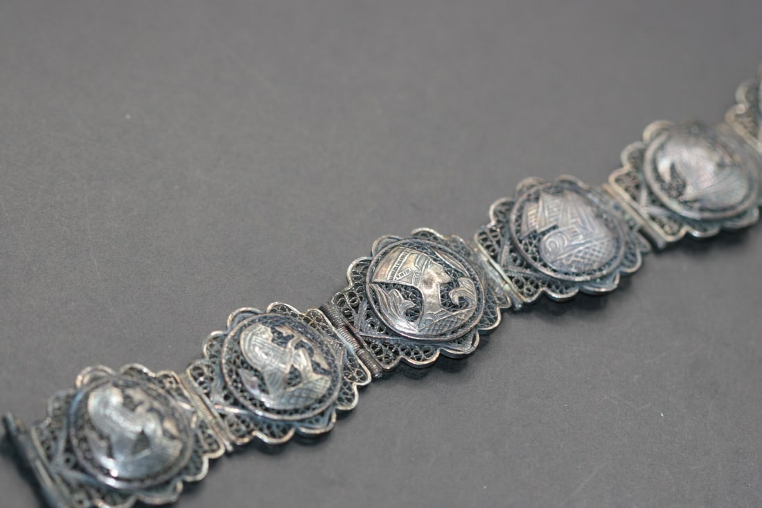 Silver Vintage Filigree Pharoh Egypt Story Bracelet Lot 631: Silver Vintage Filigree Pharoh Egypt Story Bracelet Measures 7" x 1" and it is let go on one side at the second link so sold as is.