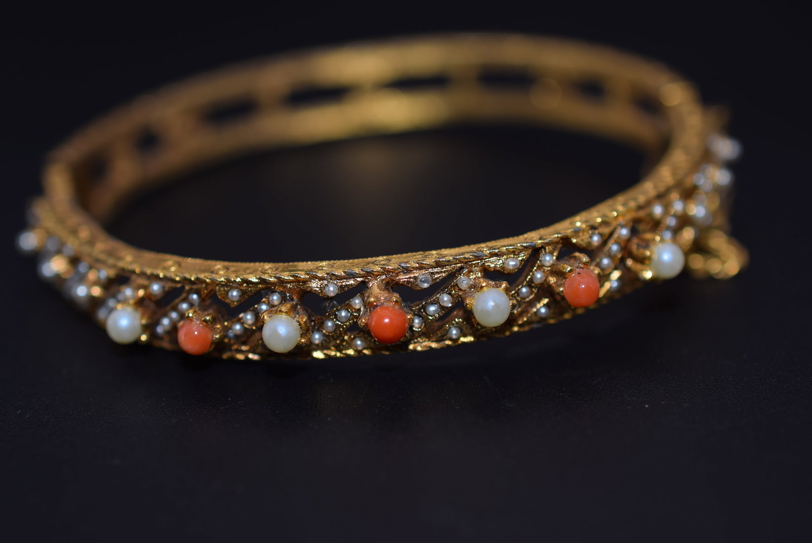 Hinged Coraline and Seed Pearl Vintage Bangle Bracelet 1950's Lot 818: Hinged Coraline and Seed Pearl Vintage Bangle Bracelet 1950's measures 2 3/8" across the inside by 3/8" Wide wear to some stones pearls