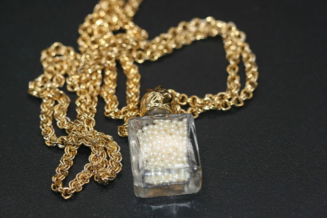 Seed Pearl Necklace in a bottle .lot#152: Seed Pearl Necklace in a bottle chain measures 35" Long and the glass bottle (cannot be opened) measures 1 1/2" x 3/4"