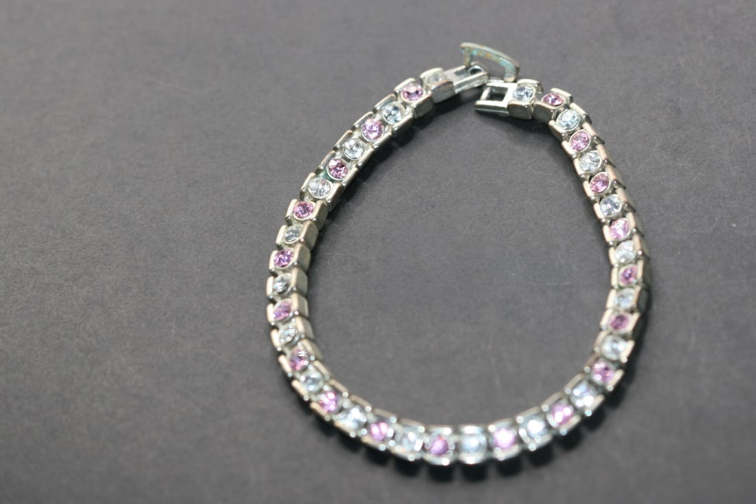 Rhinestone Tennis Bracelet Pink Clear Vintage Lot 809: Rhinestone Tennis Bracelet Vintage measures 7 3/4" long x 1/4" wide some verdigris on the clasp only nice quality weight
