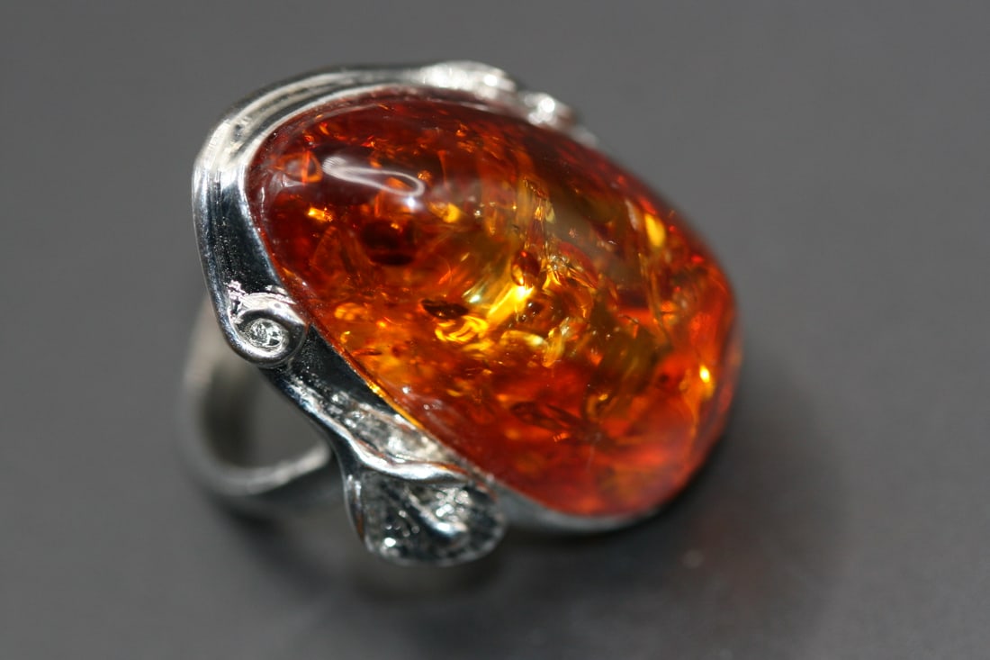 Amber Ring Massive size 11.5 top 1 1/2" LONG .Lot#98: Amber Ring Massive size 11.5 top 1 1/2" long does not appear to be sterling silver but is untested. It is simply a huge statement ring covers your finger by almost half