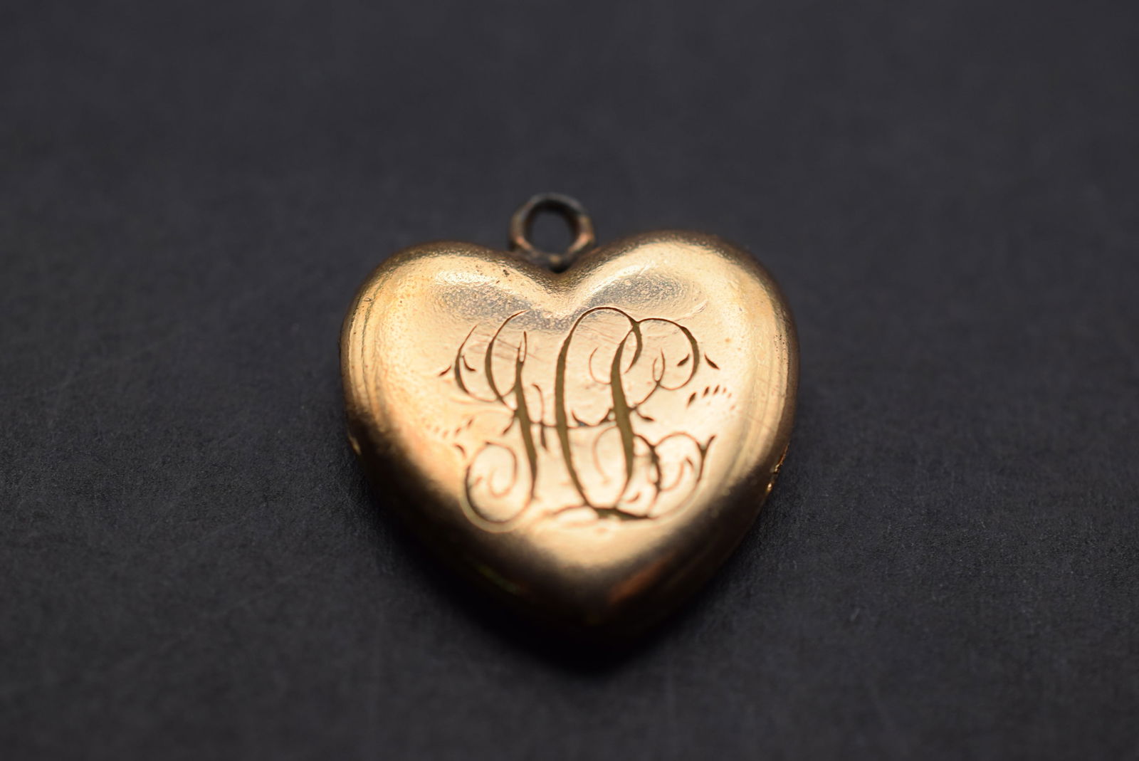 Edwardian Monogrammed Heart Locket Pendant with insterts Lot 534: Edwardian Monogrammed Heart Locket Pendant with insterts small dents on the back opens well 3/4" x 3/4"