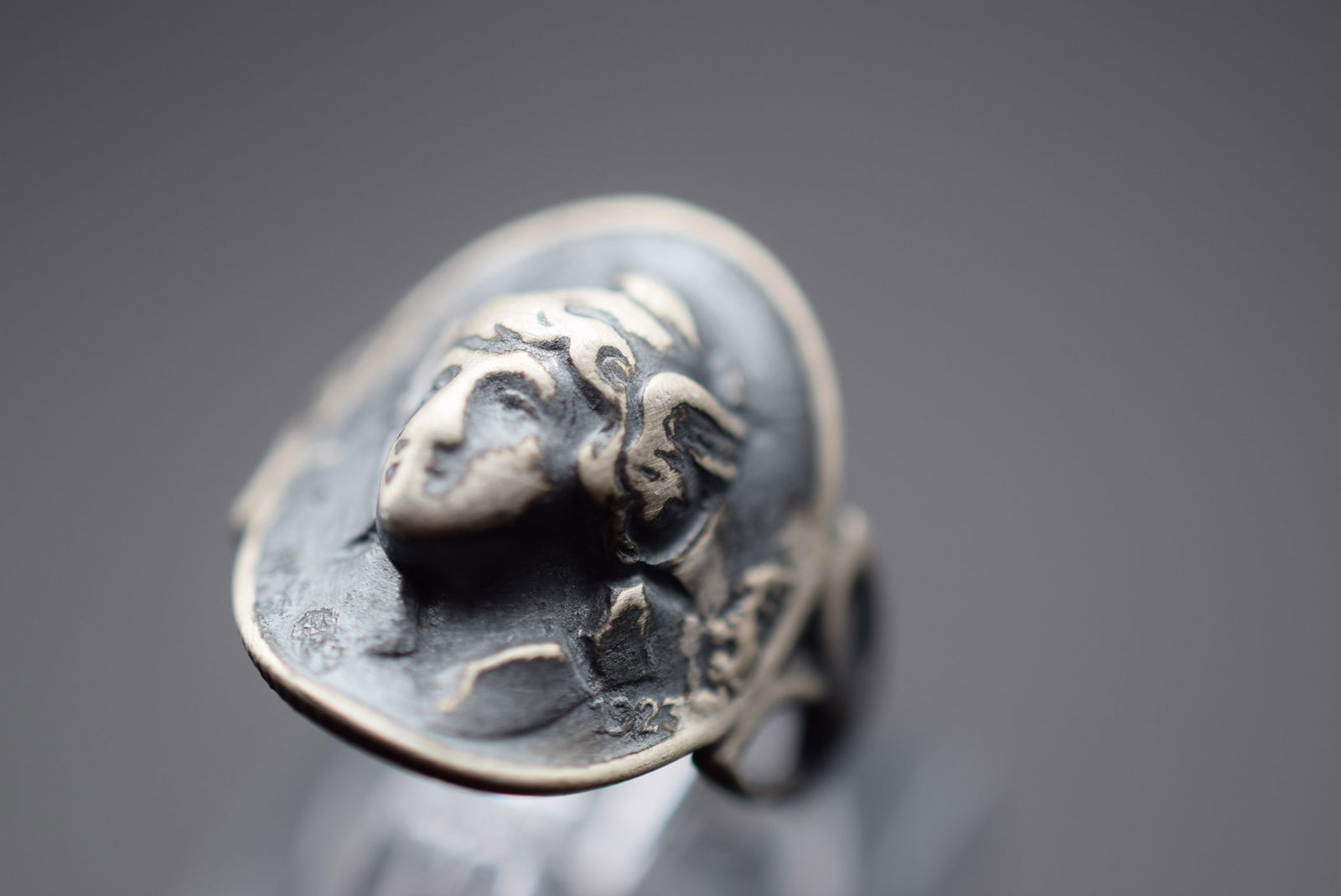 1923 Repousse Coin Ring Size 5.5 Lot 504: 1923 Repousse Coin Ring Size 5.5 Weighs 3.33 grams Top measures 3/4" signed Shank stamped Sterling and top marked:United States Of America One?..Liberty 1923 in weTrust