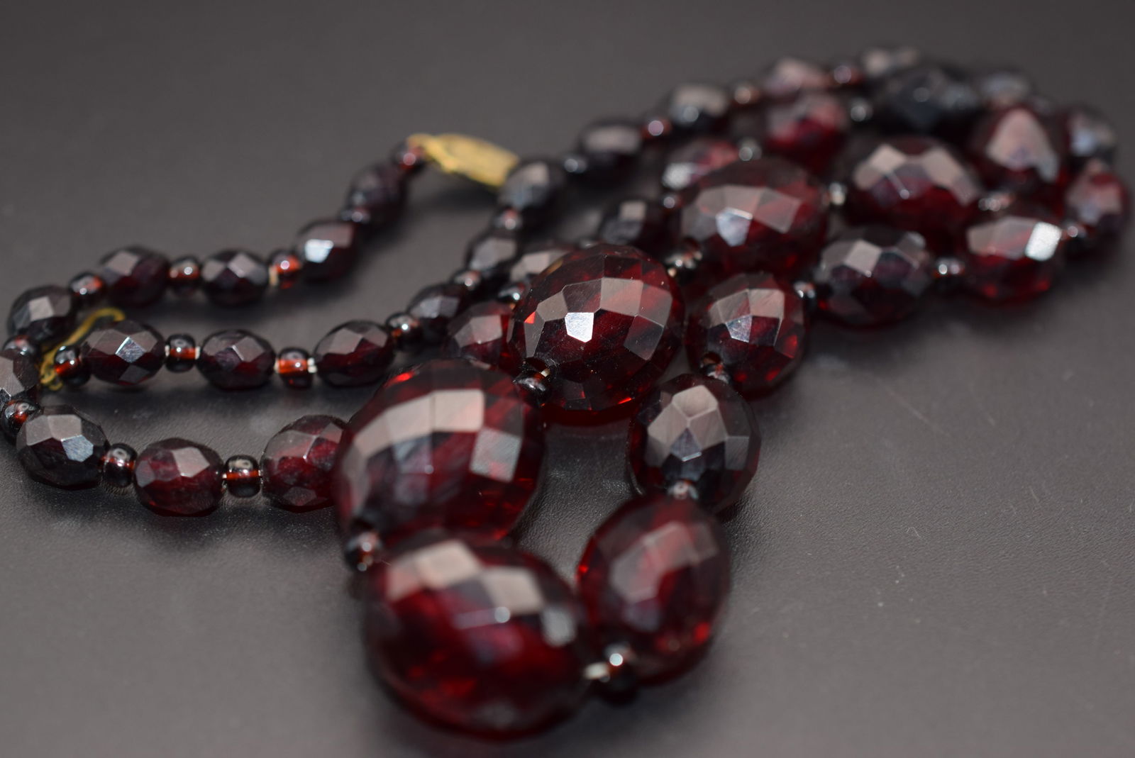Cherry Amber Faceted Vintage Necklace 24" 36 grams Lot DG 899: Cherry Amber Faceted Vintage Necklace 24" long beads measure from 8mm to 24mm needs to be restrung as there is some slack in the stringing but works fine and is solid, weighs 36 grams