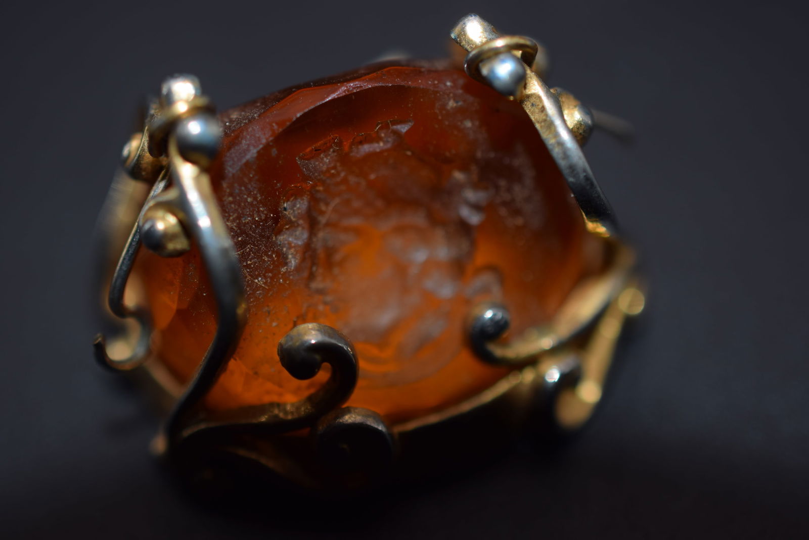 Intaglio Amber Glass FOB Vintage Lot 1107: Intaglio Amber Glass FOB Vintage measures 1" x 7/8" one hook on side needs to be re shaped