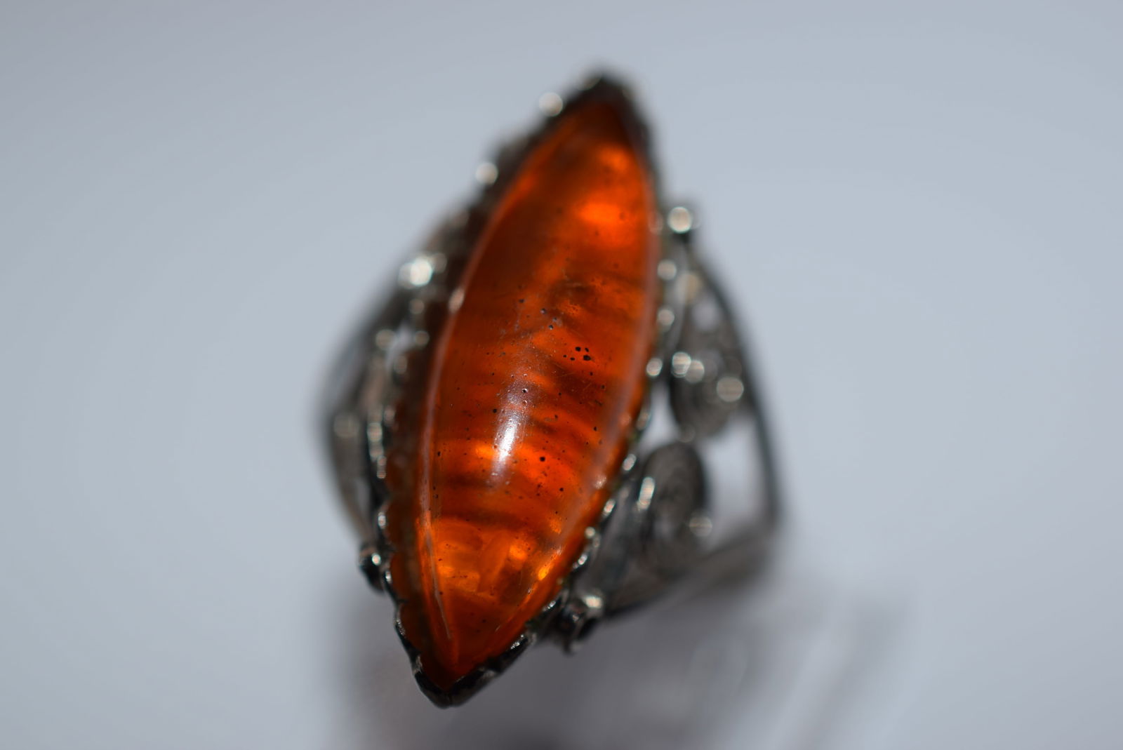 Amber Filigree Ring Genuine Amber Size 7.75 Lot EH 133: Amber Filigree Ring Genuine Amber Size 7.75 top measures 1 1/8" unsigned untested unverified if sterling, a great chunk of amber in a handmade setting