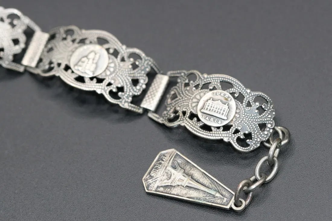 Paris Repousse Silver Souvenir Bracelet Filigree Vintage .lot#385: Paris Repousse Silver Souvenir Bracelet Filigree Vintage measures 7" long plus chain measures 2" total length 9" x 5/8" wide stamped only on the back with a star inside a crescent moon
