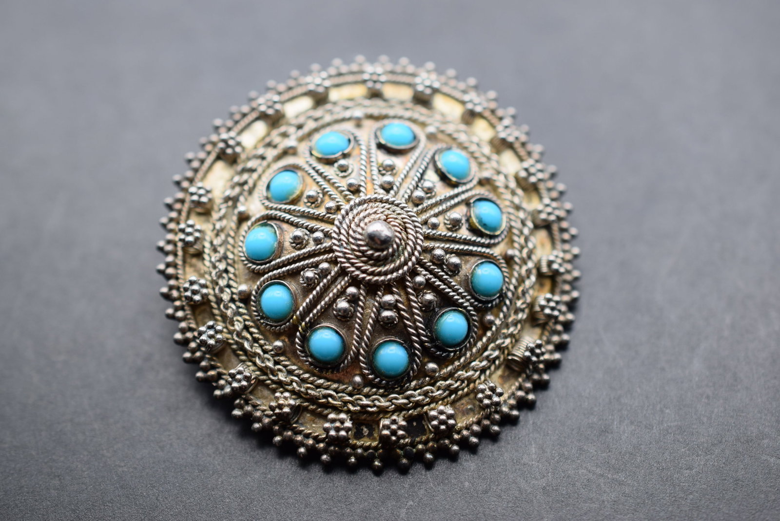 Made in Israel 935 Sterling Silver Brooch Turquoise Canatille Lot 564: Made in Israel 935 Sterling Silver Brooch Turquoise Canatille measures 1 3/4" in diameter weighs 10.58 grams