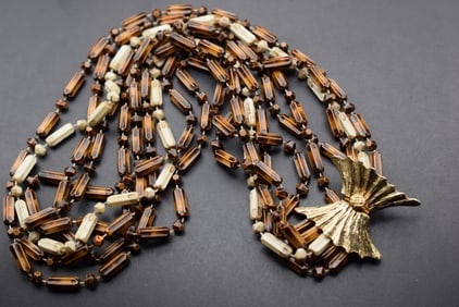 Vogue Lightest Multi Strand Vintage Necklace 1960's signed Lot 653: Vogue Lightest Multi Strand Vintage Necklace 1960's signed on the back of the clasp Vogue JLRY 5 strands measures 23 1/2" Long Clasp closes nicely and true to its name very unique and lovely