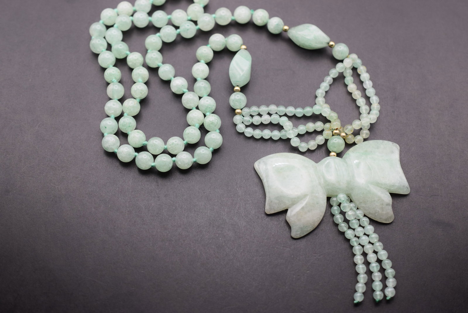 Jadeite Green Necklace Knotted with Pendant Lot 841: Jadeite Green Necklace Knotted with Pendant 27" Long pendant measures 2 1/2" wide and is 3" with the drops