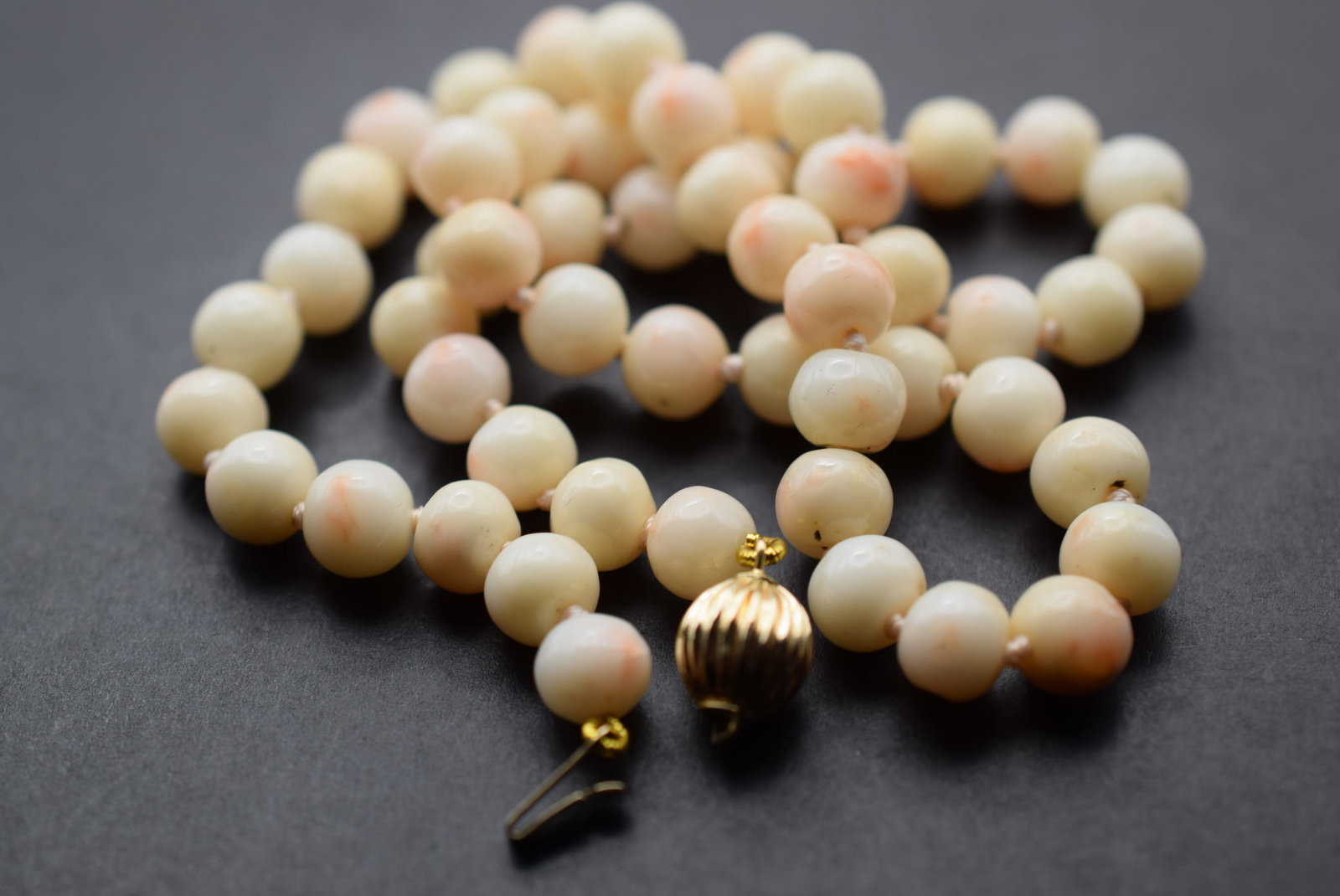 14K Gold Barrel Round Clasp on Genuine Angelskin Coral Knotted Vintage Lot 897: 14K Gold Barrel Round Clasp on Genuine Angelskin Coral Knotted Vintage measures 15 1/2" long and the beads measure 6mm