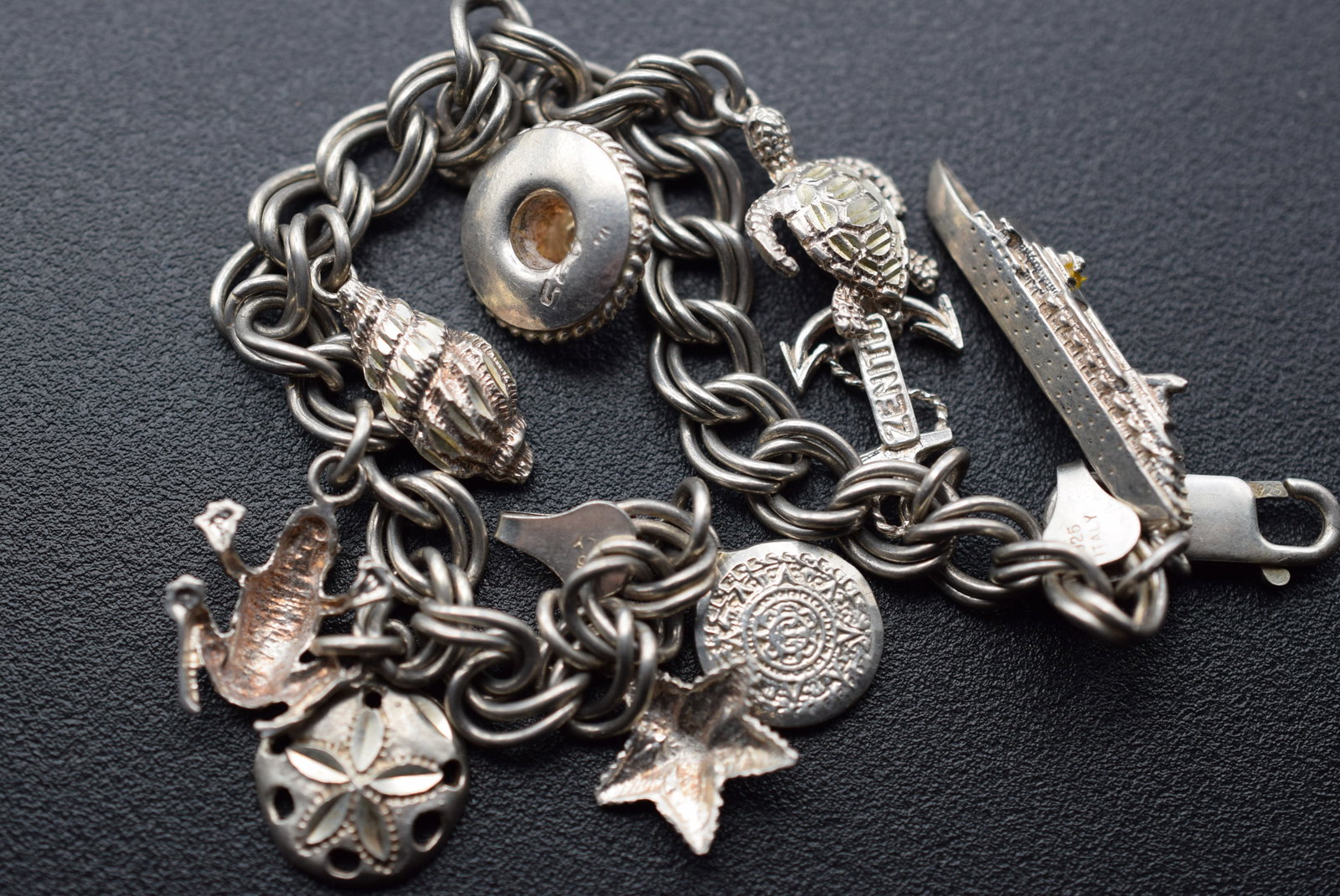 Sterling Charm Bracelet w charms MV Zenith Vintage Lot 950: Sterling Charm Bracelet w charms MV Zenith Vintage measures 7" long and is marked 925 as well as the silver charms including MV Zenith ship in operation from 1992 to 2022 after being sold to india for