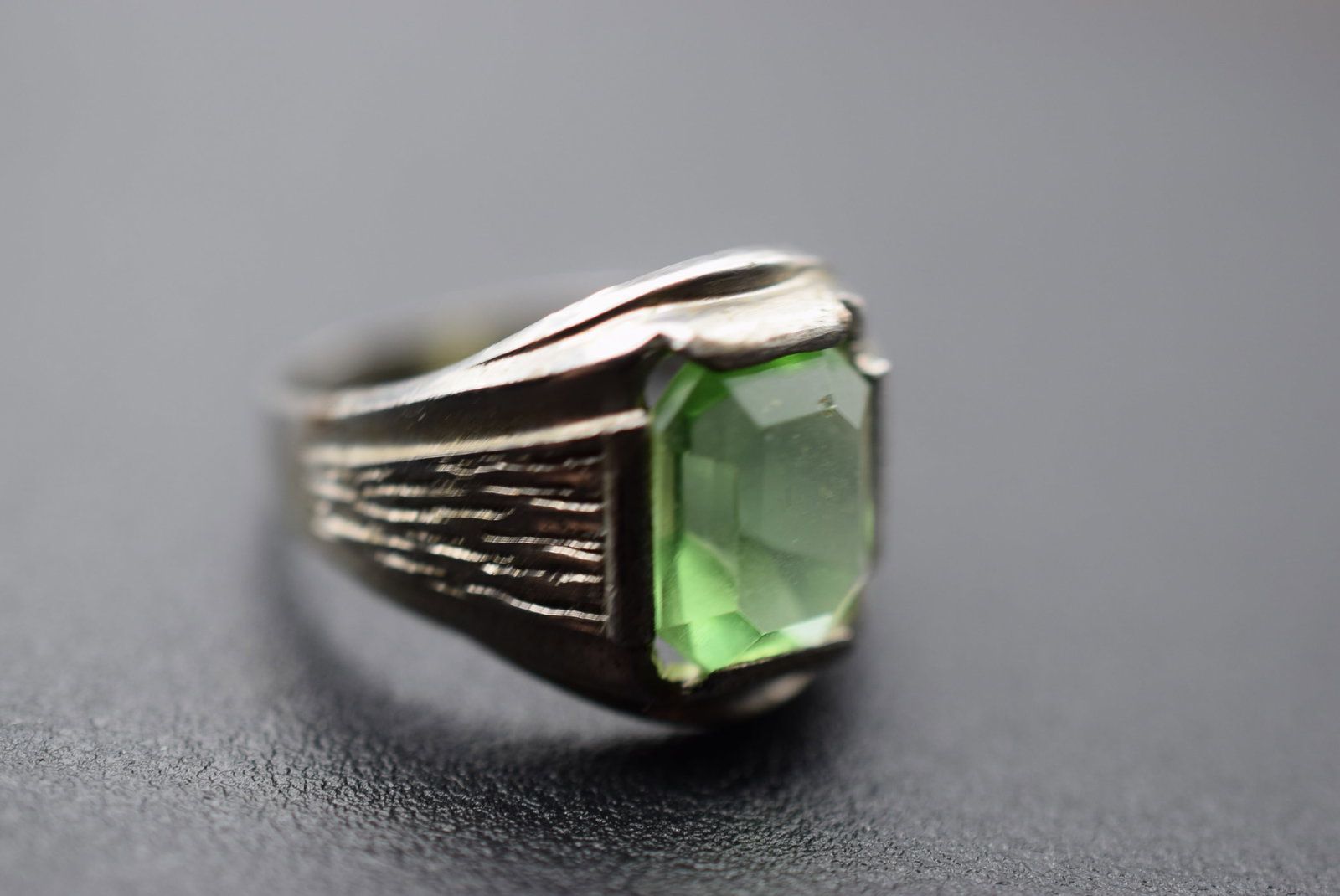 Sterling Olive Rhinestone Ring Size 5.5 Lot 998: Sterling Olive Rhinestone Ring Size 5.5 measures 5/8" wide at top and is signed Sterling inside weighs 3.10 grams